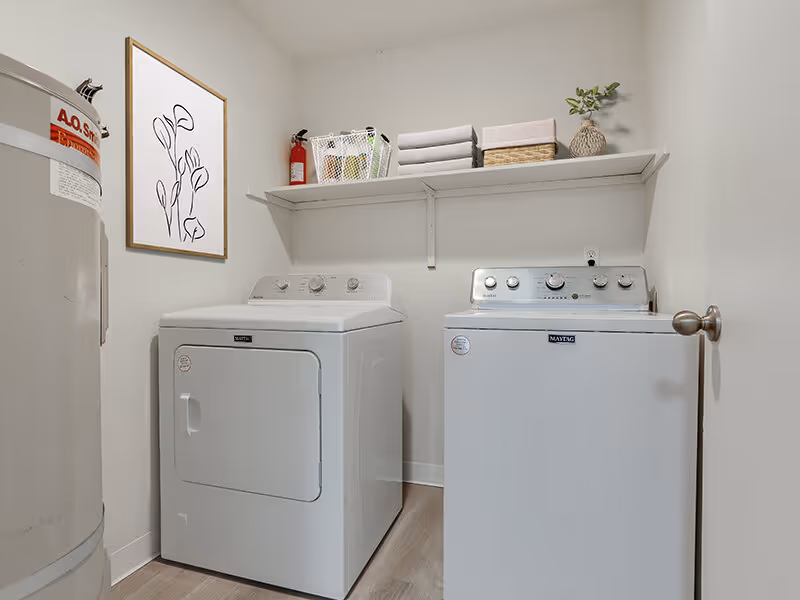 Laundry room with white appliances