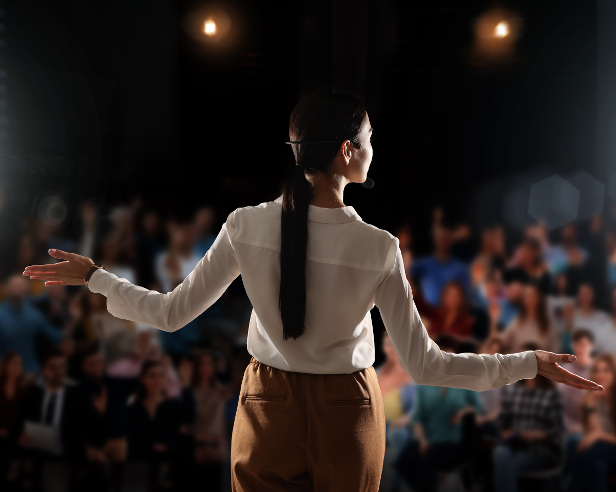 Woman speaking on stage. Michelle Margaret Marques Coaching