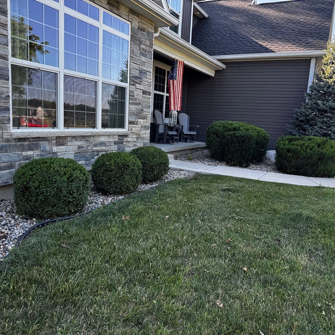 Shrub trimming and upkeep service maintaining clean, healthy landscape beds