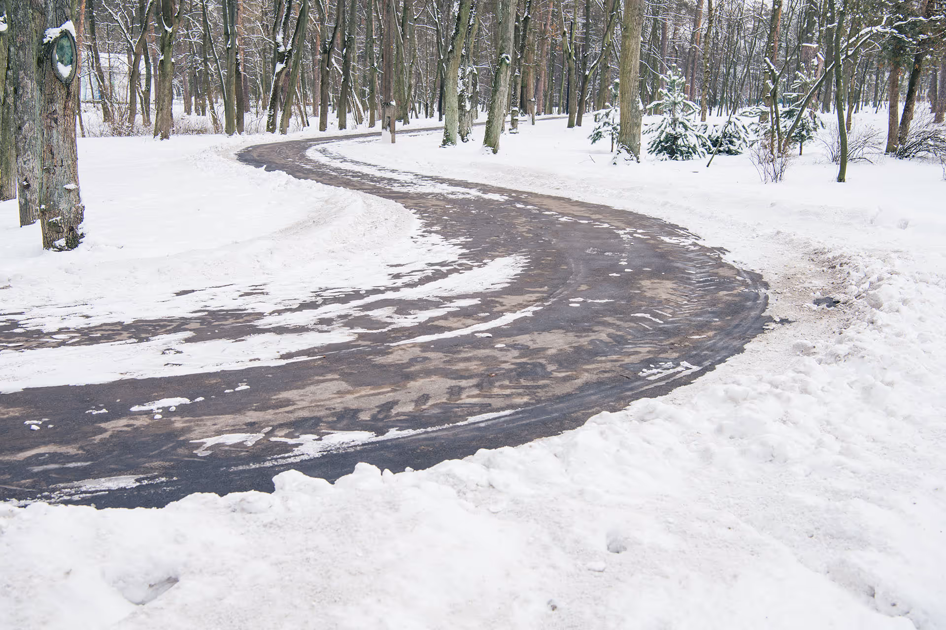 Snow plowing service clearing driveway after winter storm