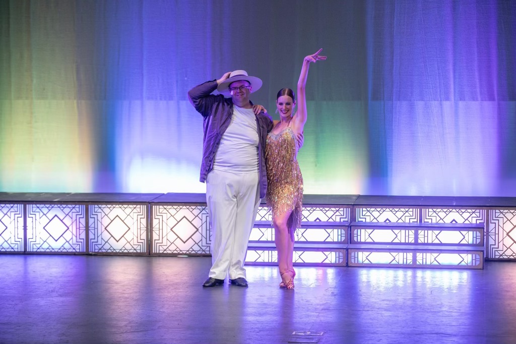 Contestant in white hat with pro dancer