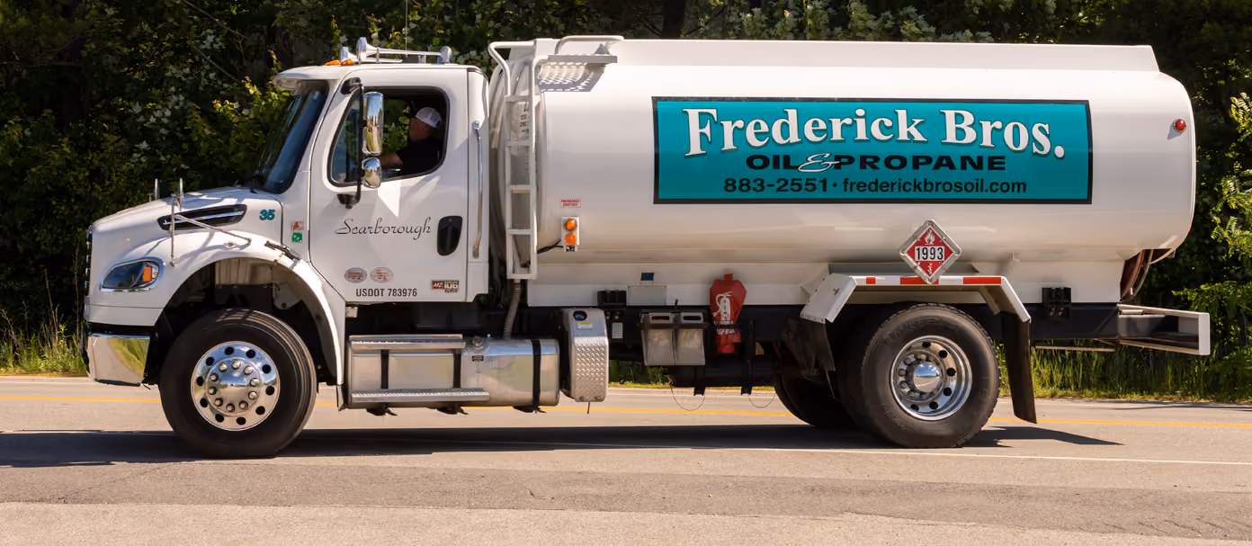 Frederick Bros. oil and propane delivery truck driving on a road.