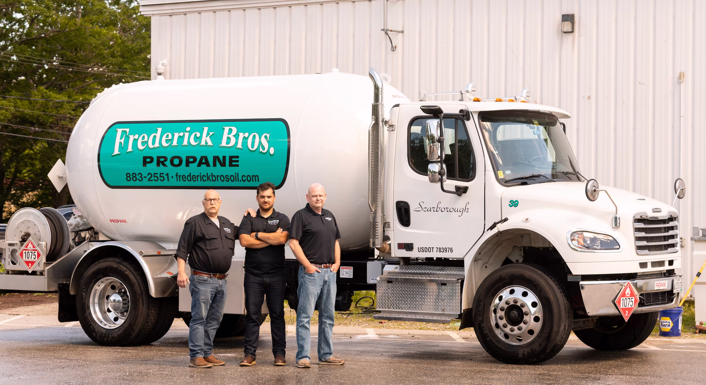Kevin Frederick, Devin Frederick, and Steve Nason standing in front of a Frederick Bros. propane truck.