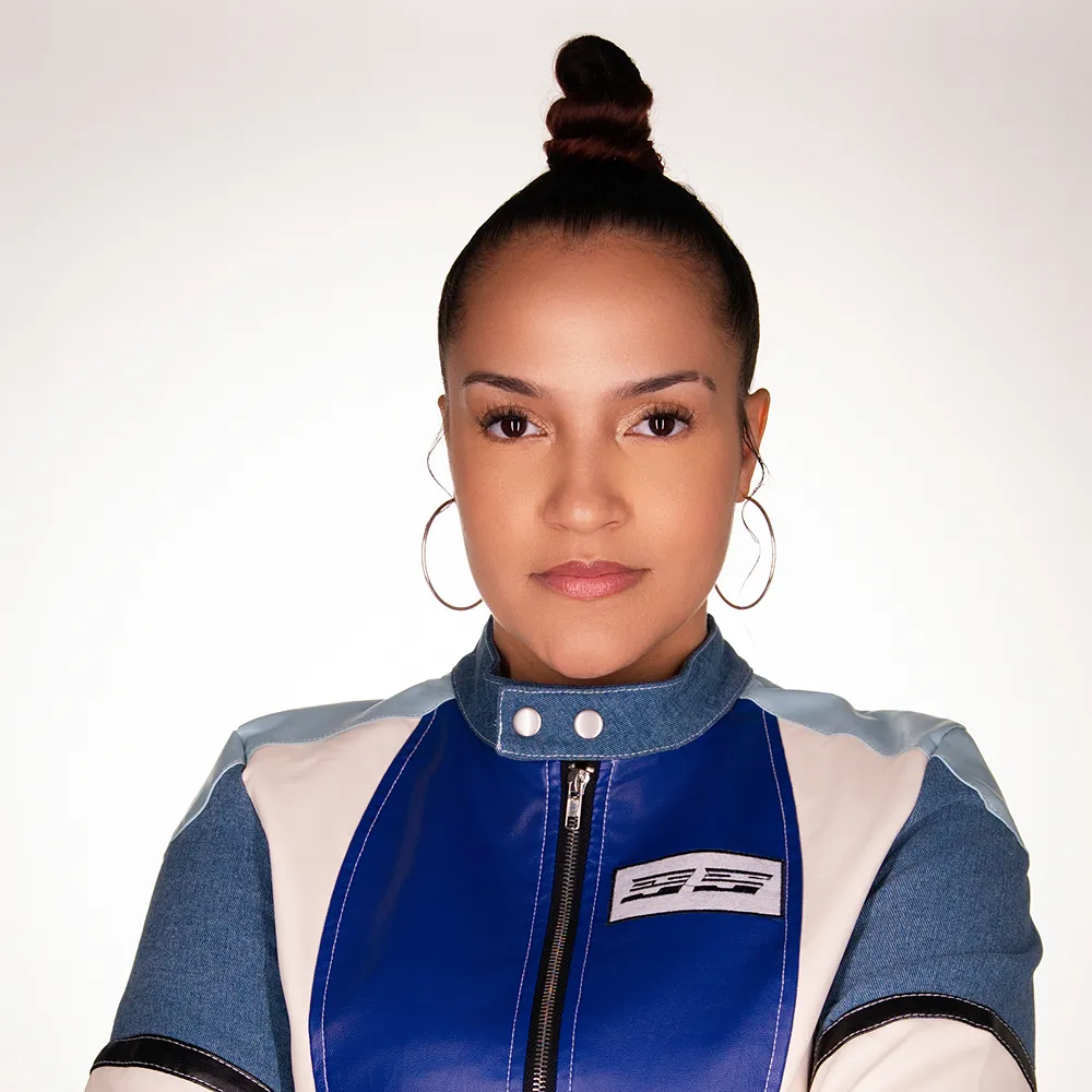 Portrait of Jay in a blue and white moto jacket.