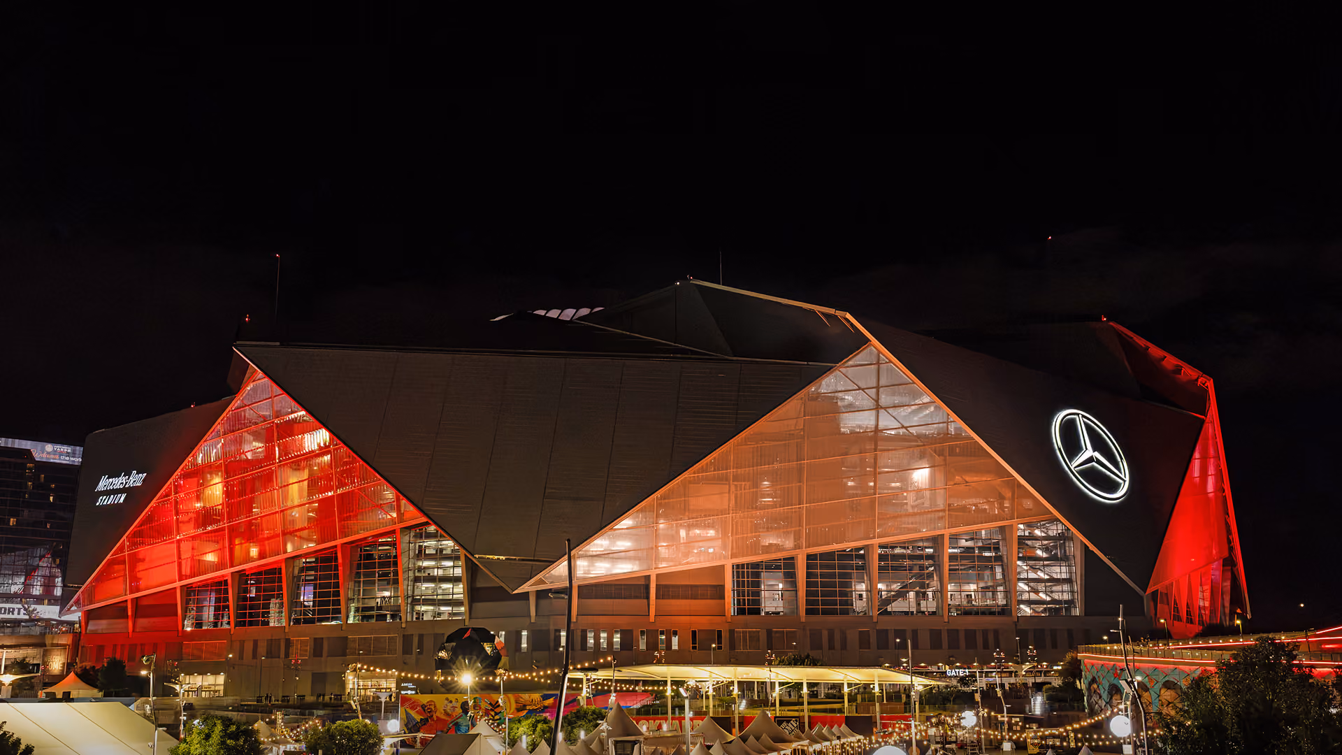 Mercedes-Benz Stadium lit in red at night.
