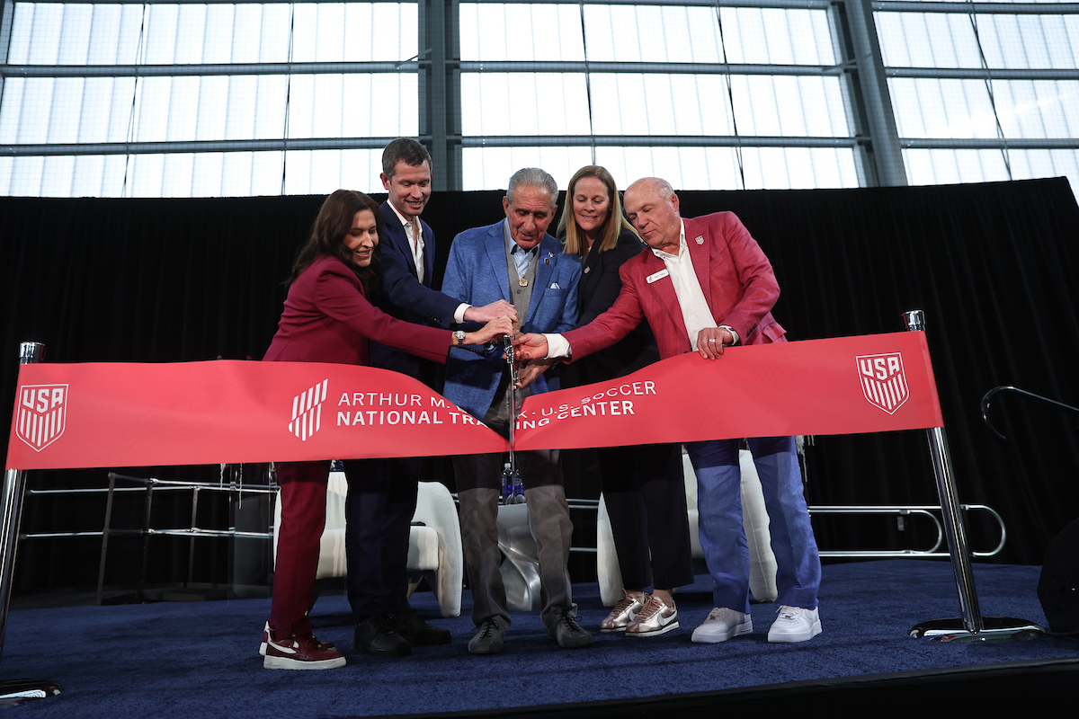 Leaders cut a red ribbon at the opening of the Arthur M. Blank U.S. Soccer National Training Center.