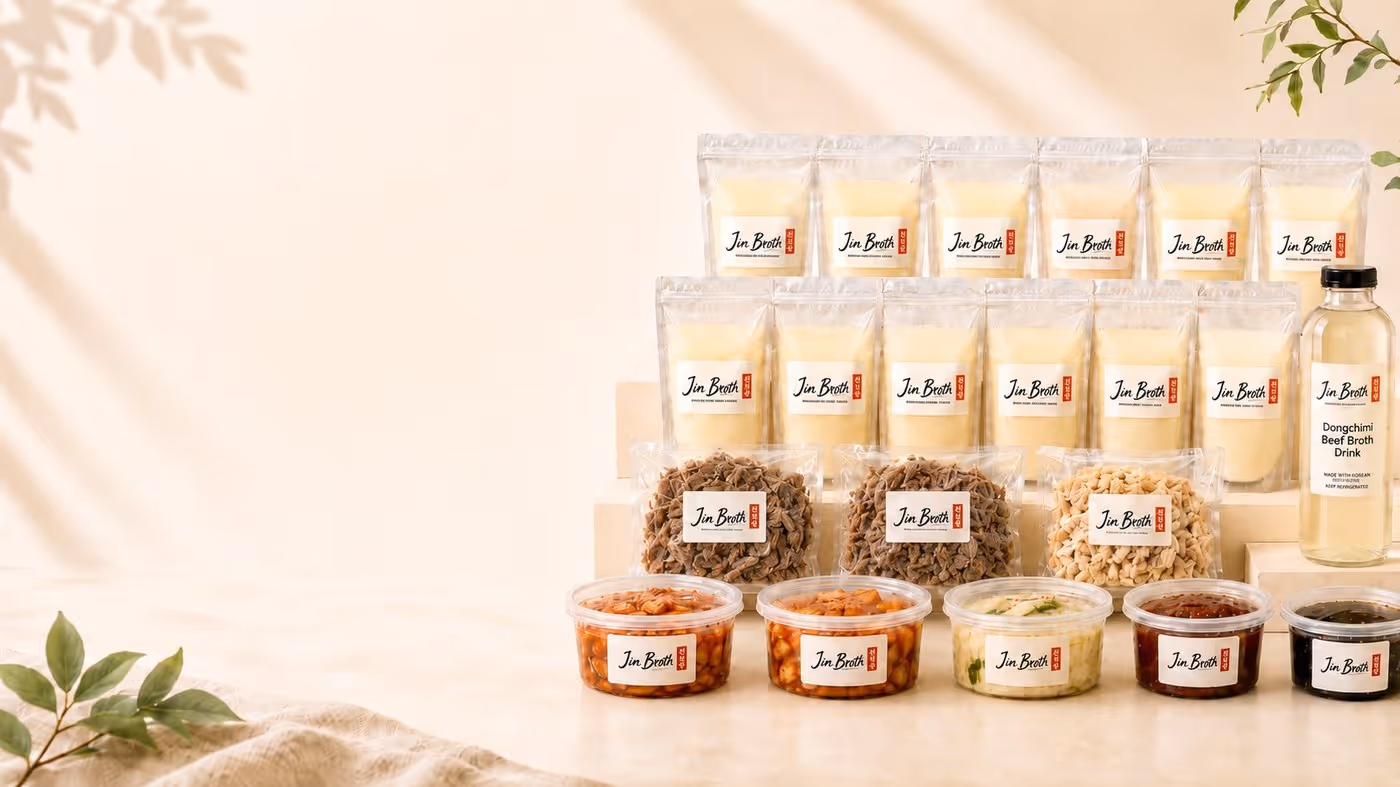 Assorted Jin Broth packaged food items including broth pouches, dried meat, kimchi, and a Dongchimi beef broth drink bottle.