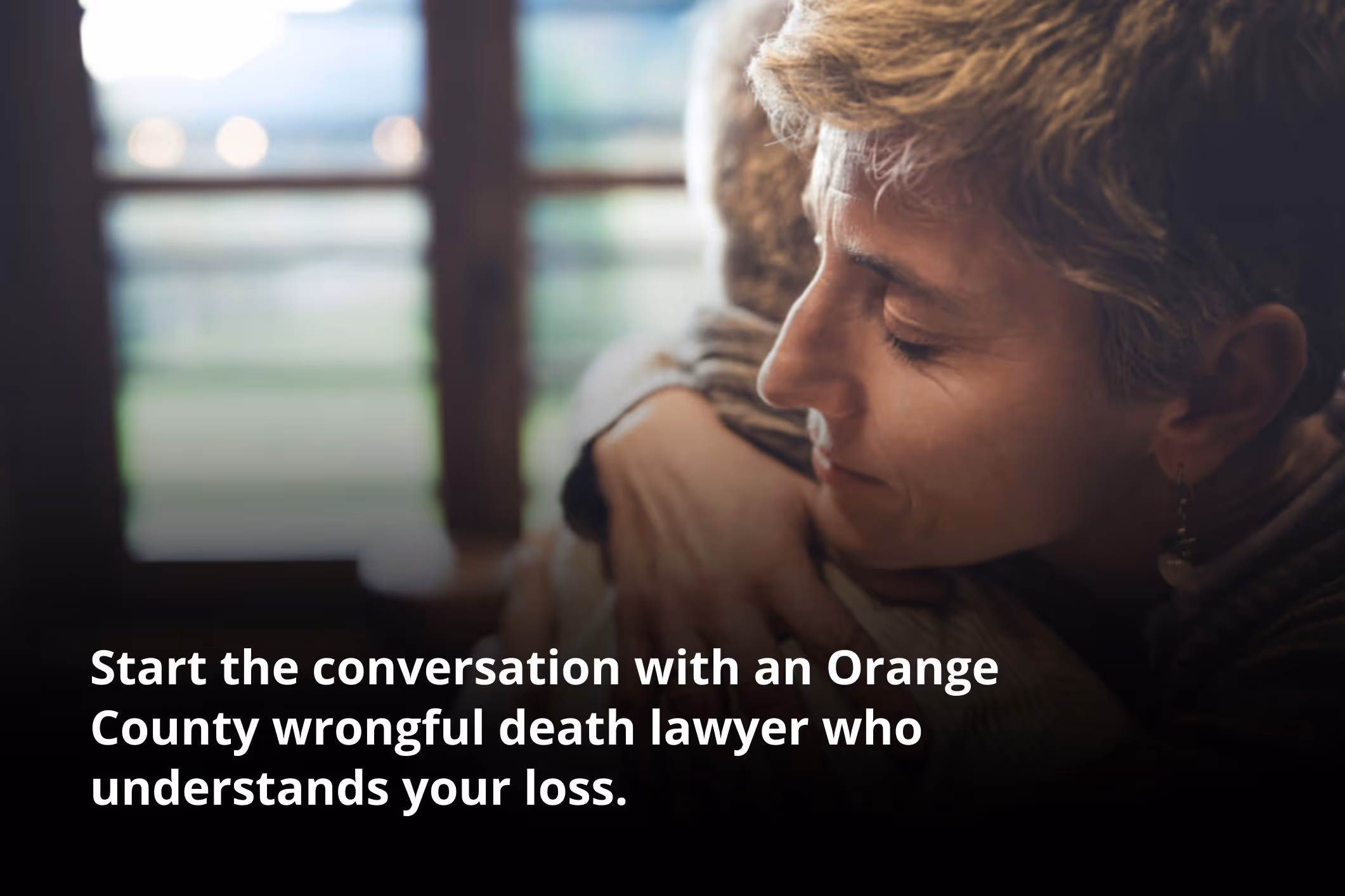 Two people embracing in grief, representing the compassion of an Orange County wrongful death lawyer.