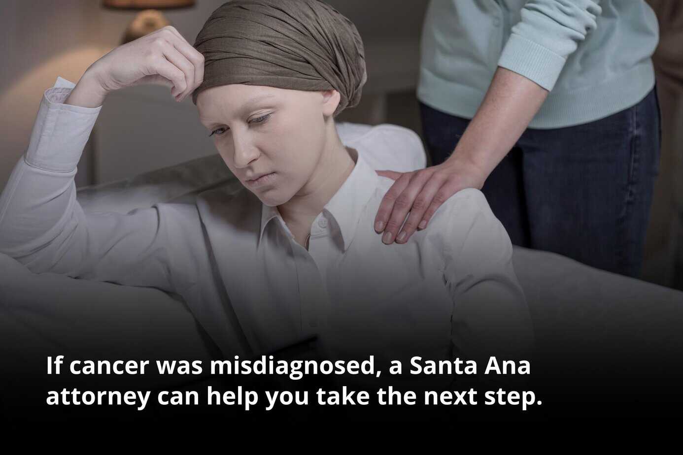 Woman sitting with head down and hand on forehead, representing a Santa Ana cancer misdiagnosis attorney case.