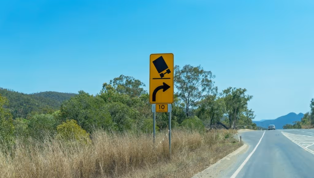 Freeway sign showing possible truck rollover accident dangers