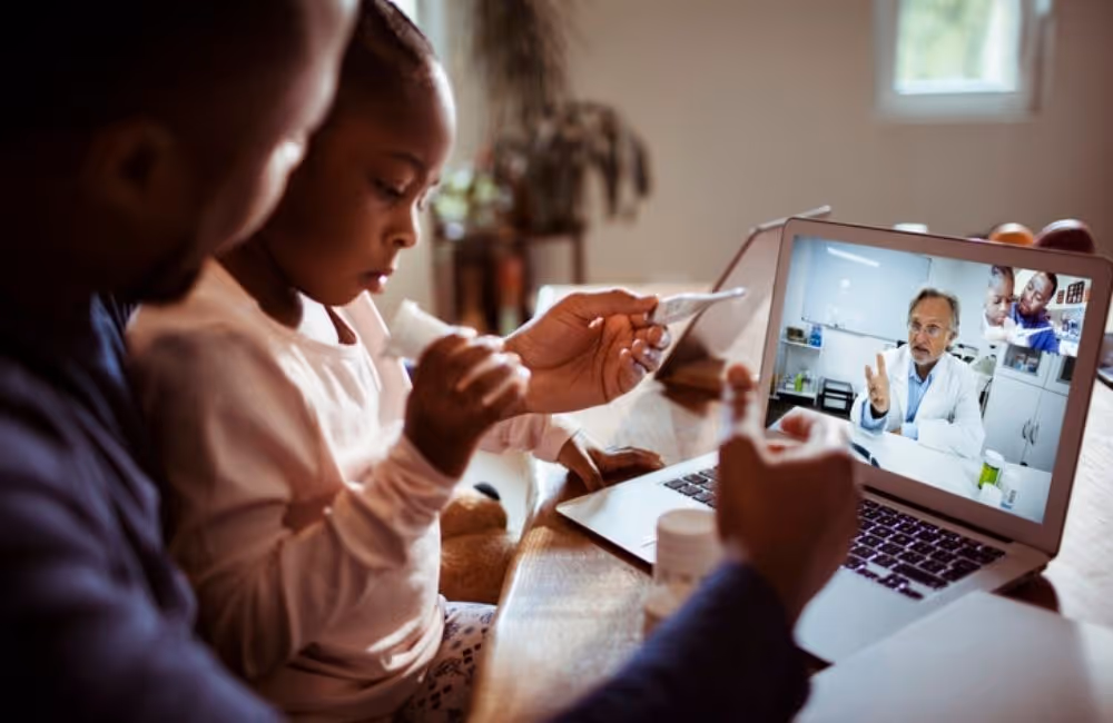 An African American father sits with his young daughter at a table as they receive a virtual health consultation on a laptop.|Rear shot of a woman monitoring her glucose levels through an app on a smartphone. Telemedicine allows doctors to monitor patient statuses remotely.|An African American father sits with his young daughter at a table as they receive a virtual health consultation on a laptop.