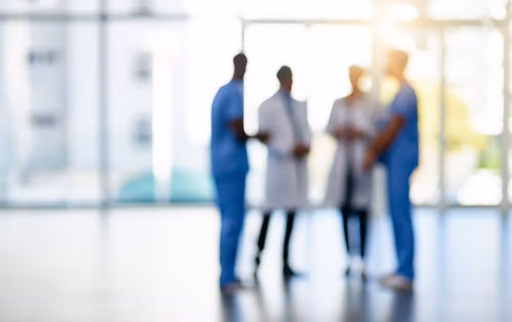 Blurred image of doctors and medical staff meeting in a hospital hallway