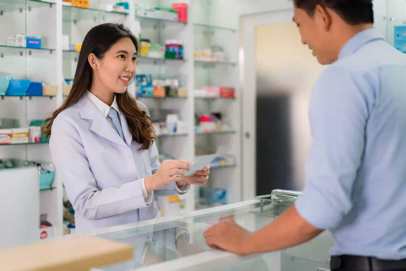 Pharmacist prescribes medicine to a senior patient