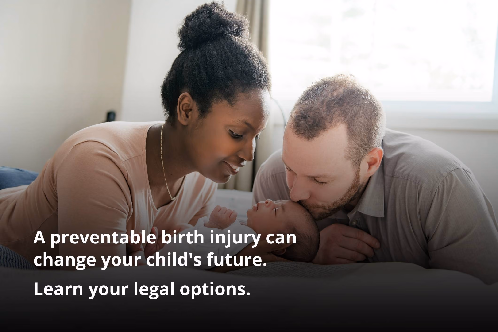 Worried parents sitting on bed with baby, illustrating the need for a Tustin birth injury lawyer.