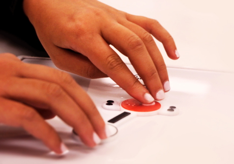 Close-up of hands creating a molecular model using Alchemy's Cassie Particulate Chemistry set. 