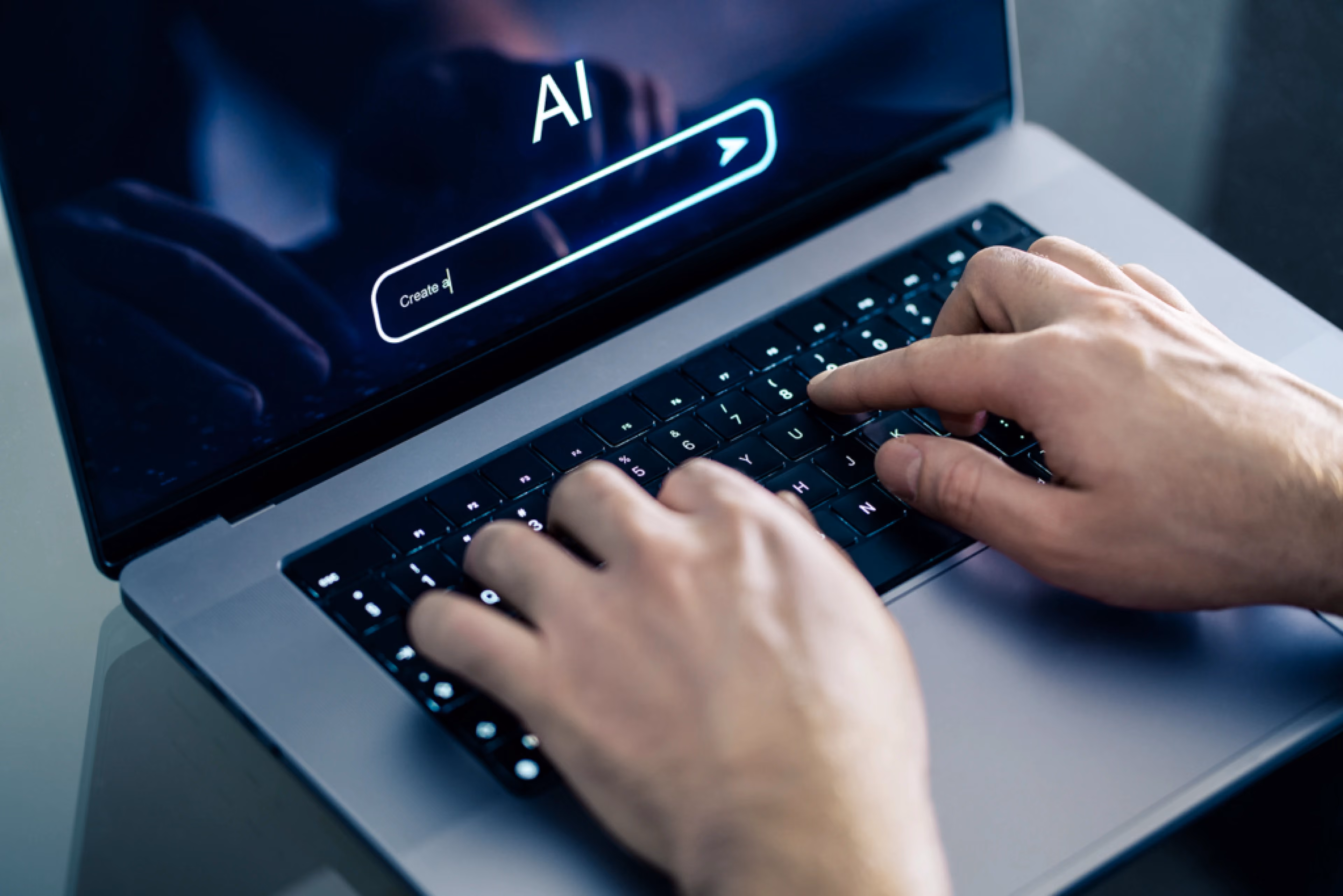 Close-up of hands typing an AI prompt on a laptop, representing how AI tools are changing academic cheating and exam integrity.