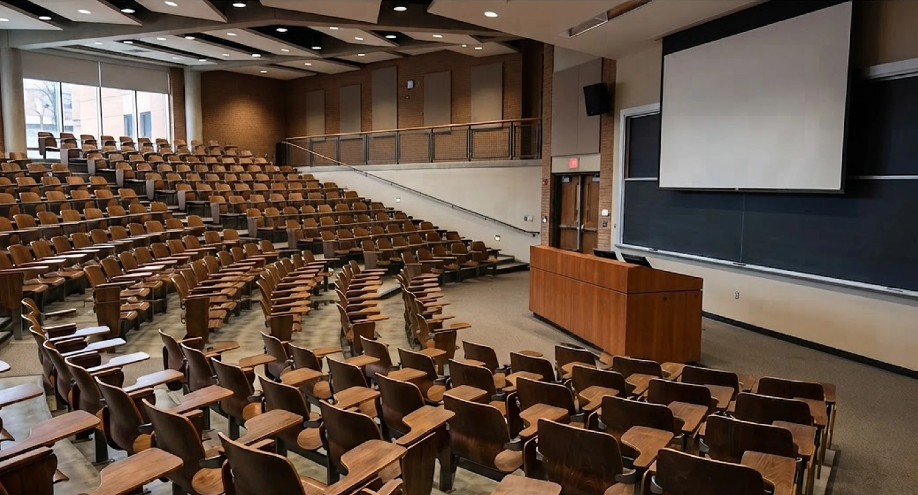 Empty university lecture hall representing the shift from take-home to in-person exams+