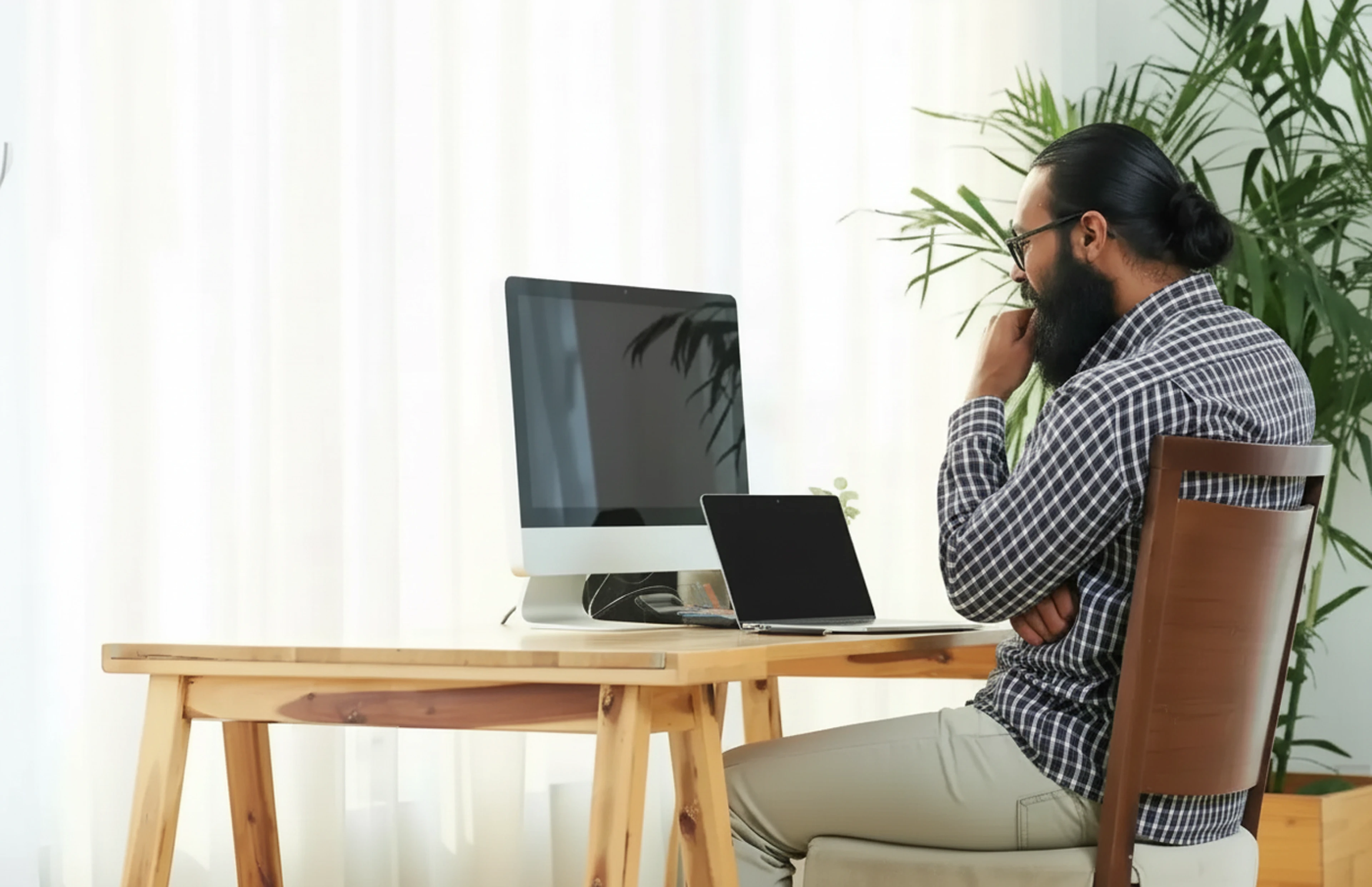 Professional reviewing online assessment results across multiple devices in a modern workspace, illustrating scalable and flexible online proctoring.