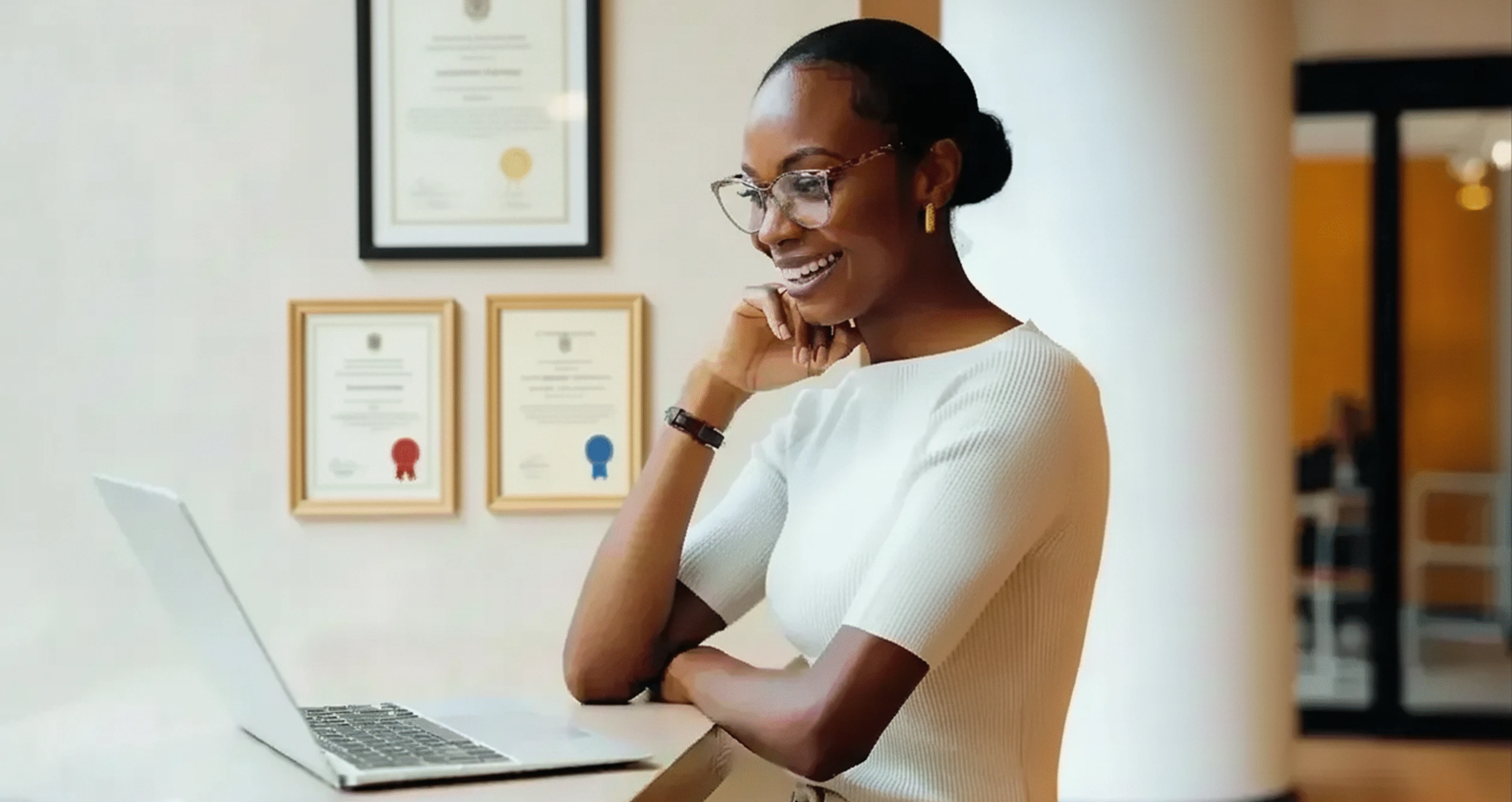 Professional woman reviewing digital credentials on a laptop, symbolizing assessment security and credential integrity in online education and certification programs.