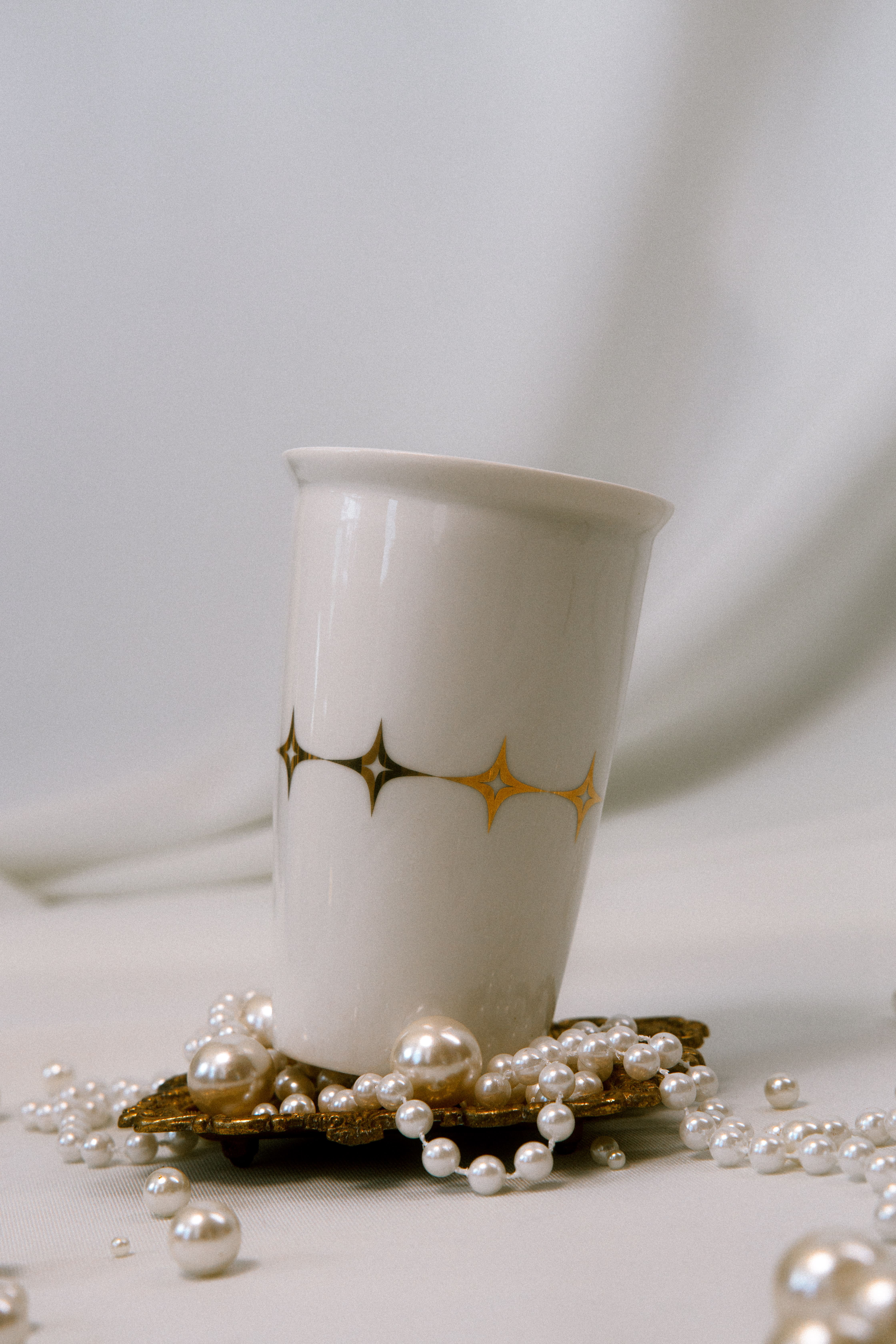 Room corner with wooden drawers and shelves, adorned with eclectic framed black-and-white and colorful cartoon-style artwork on a dark blue wall.