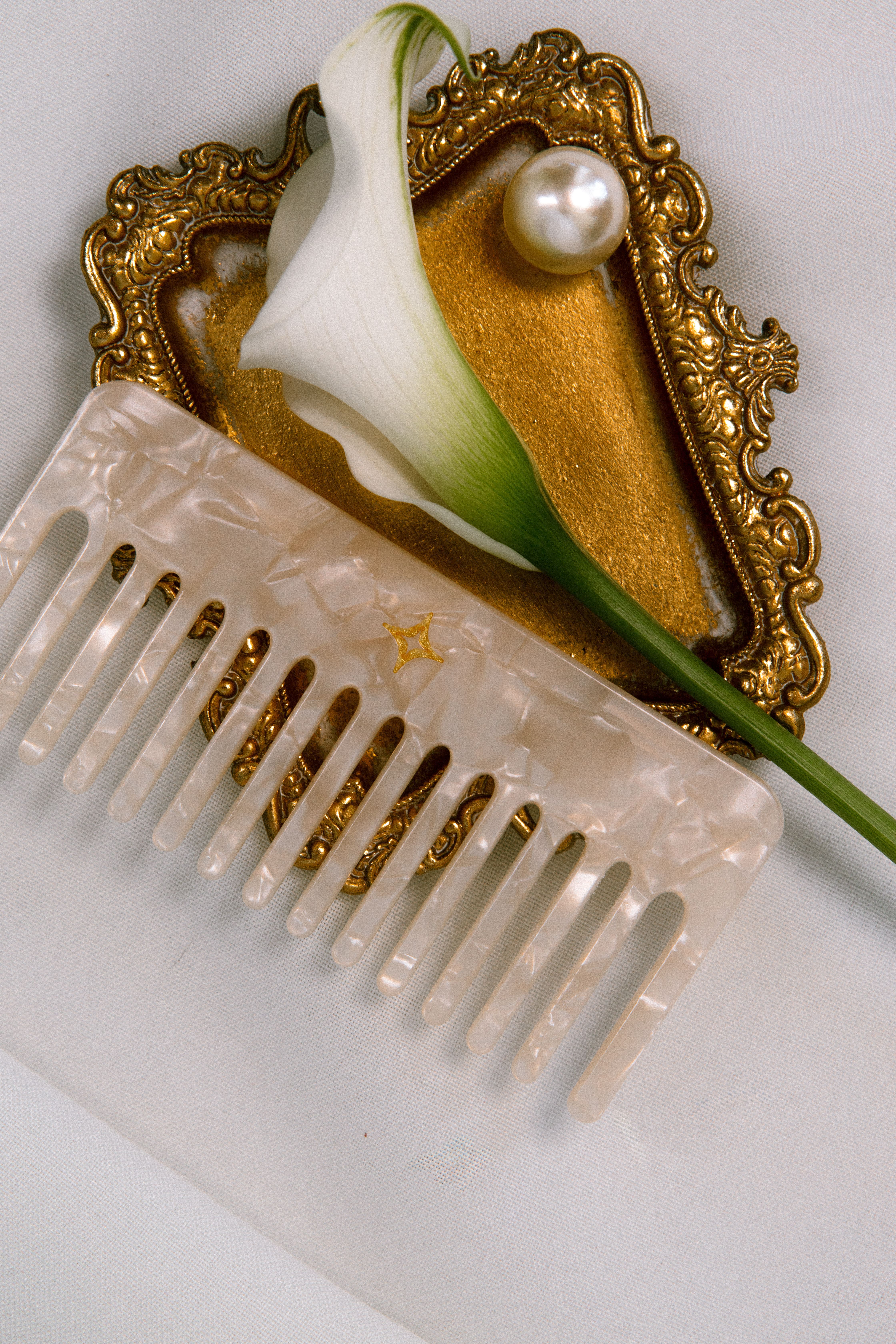 Room corner with wooden drawers and shelves, adorned with eclectic framed black-and-white and colorful cartoon-style artwork on a dark blue wall.