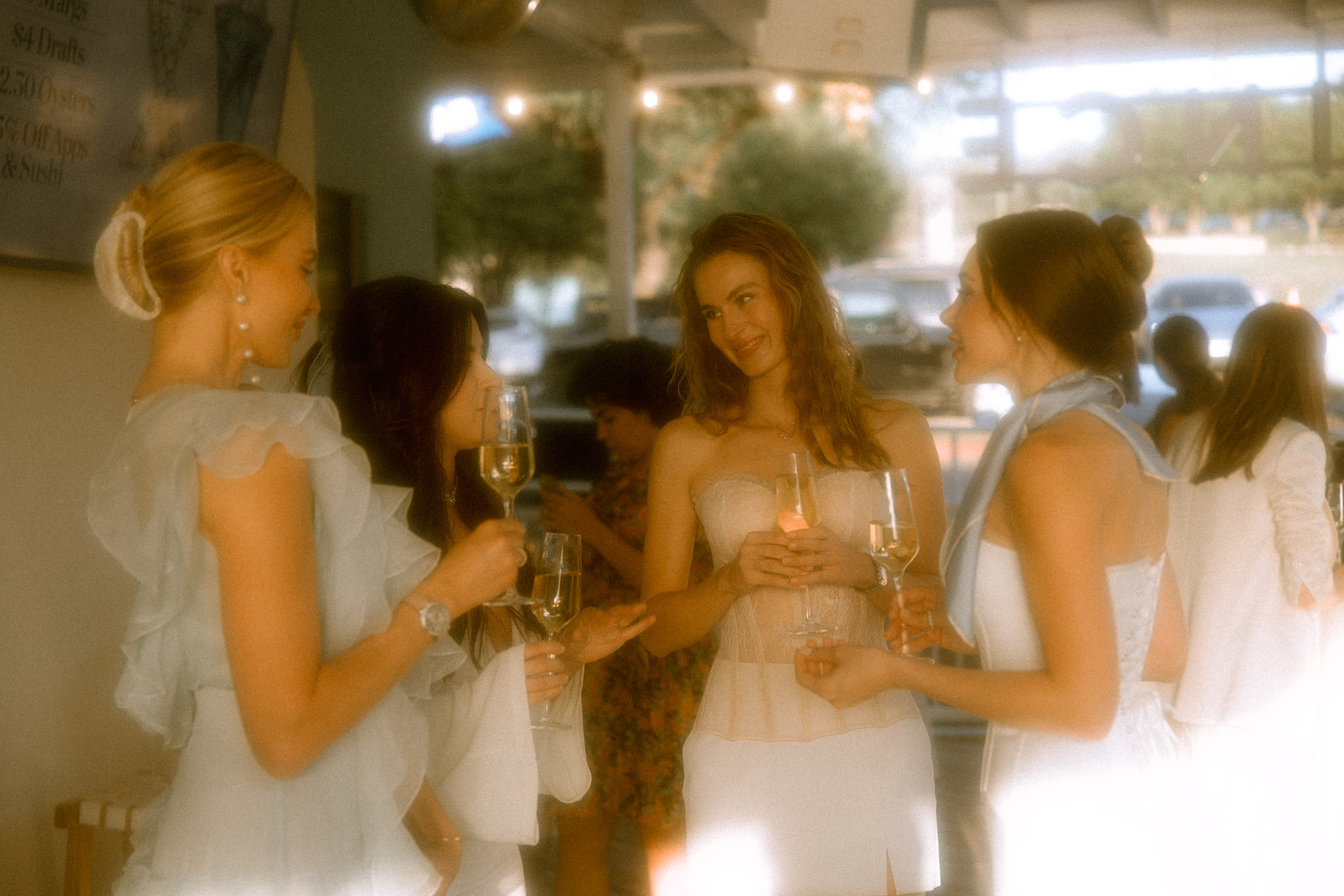 Five decorative candles in uniquely shaped holders including marbled black and green, speckled beige, multicolor, orange, and textured cream designs.