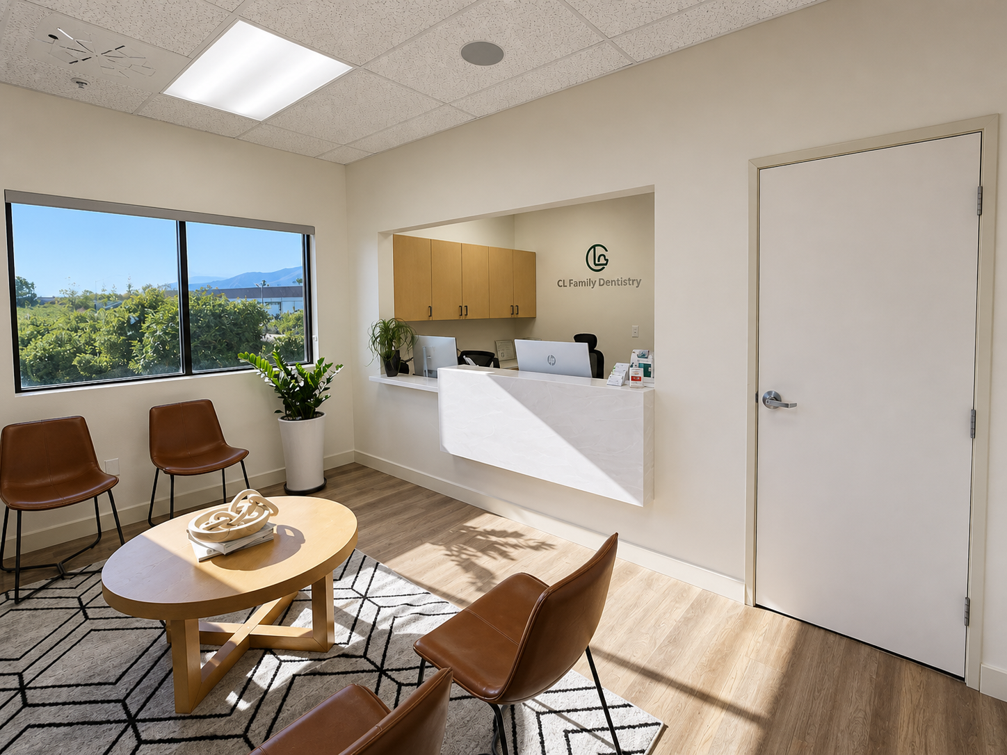 Modern reception area at Choi & Lee Family Dentistry in La Verne with comfortable seating, a curved white desk, mountain views through large windows, and natural lighting