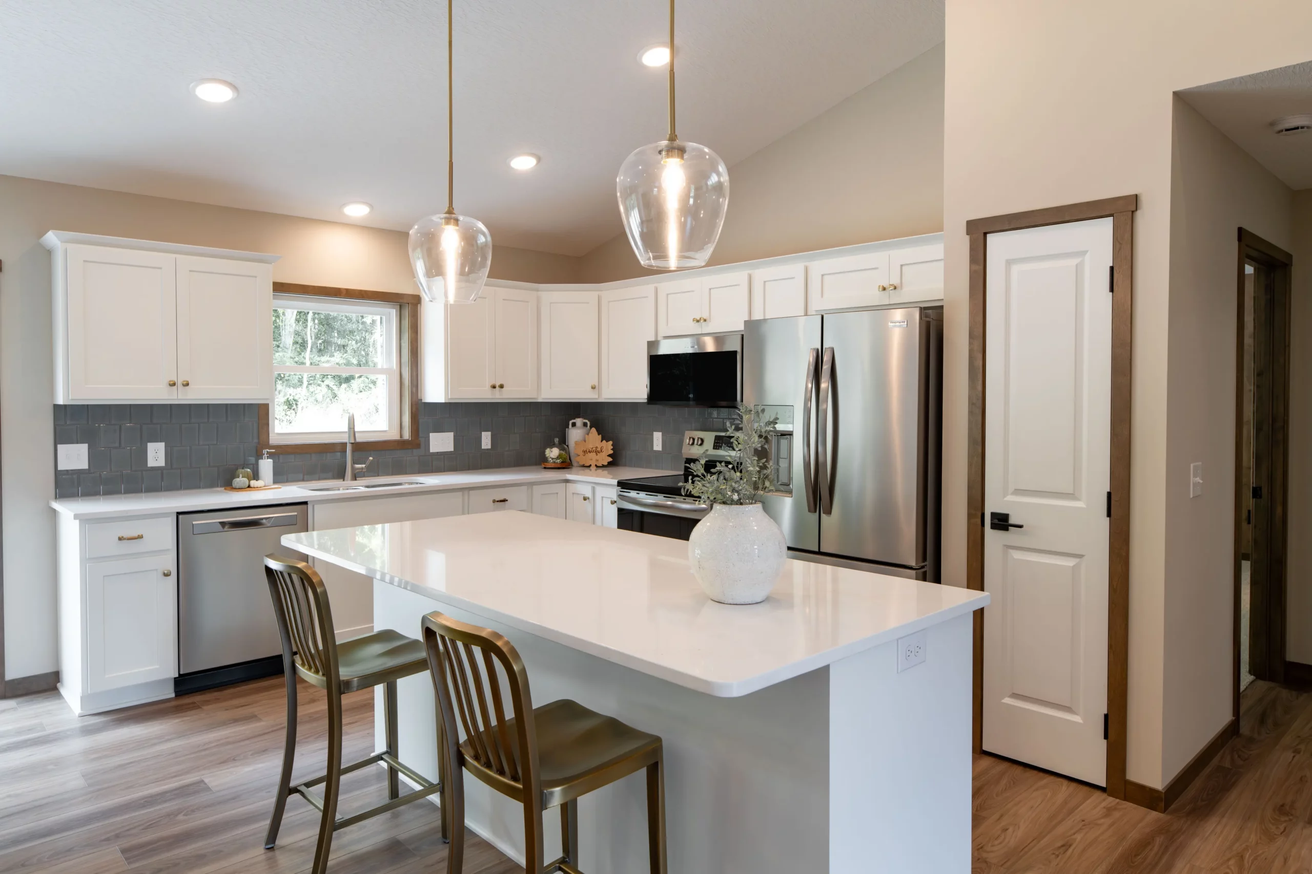 clean-kitchen-with-island-and-white-cabinets-scaled