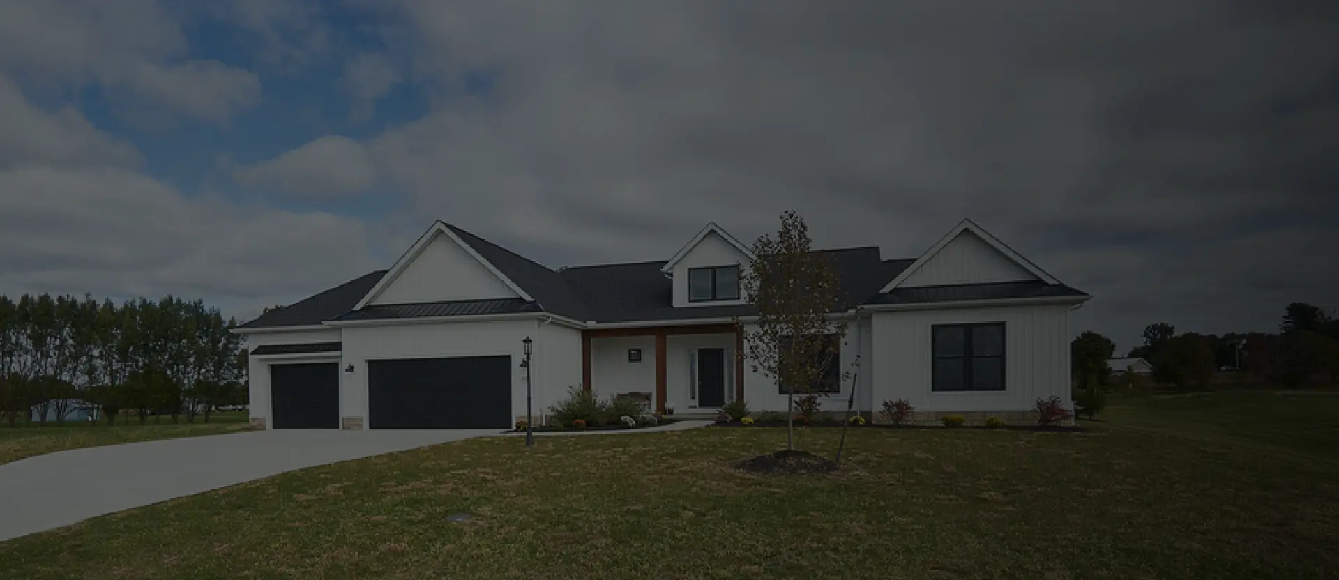 white-siding-home-with-driveway-dark-gradient