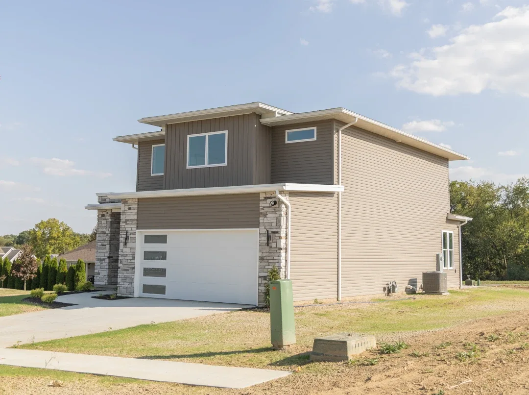 two story home with modern garage door