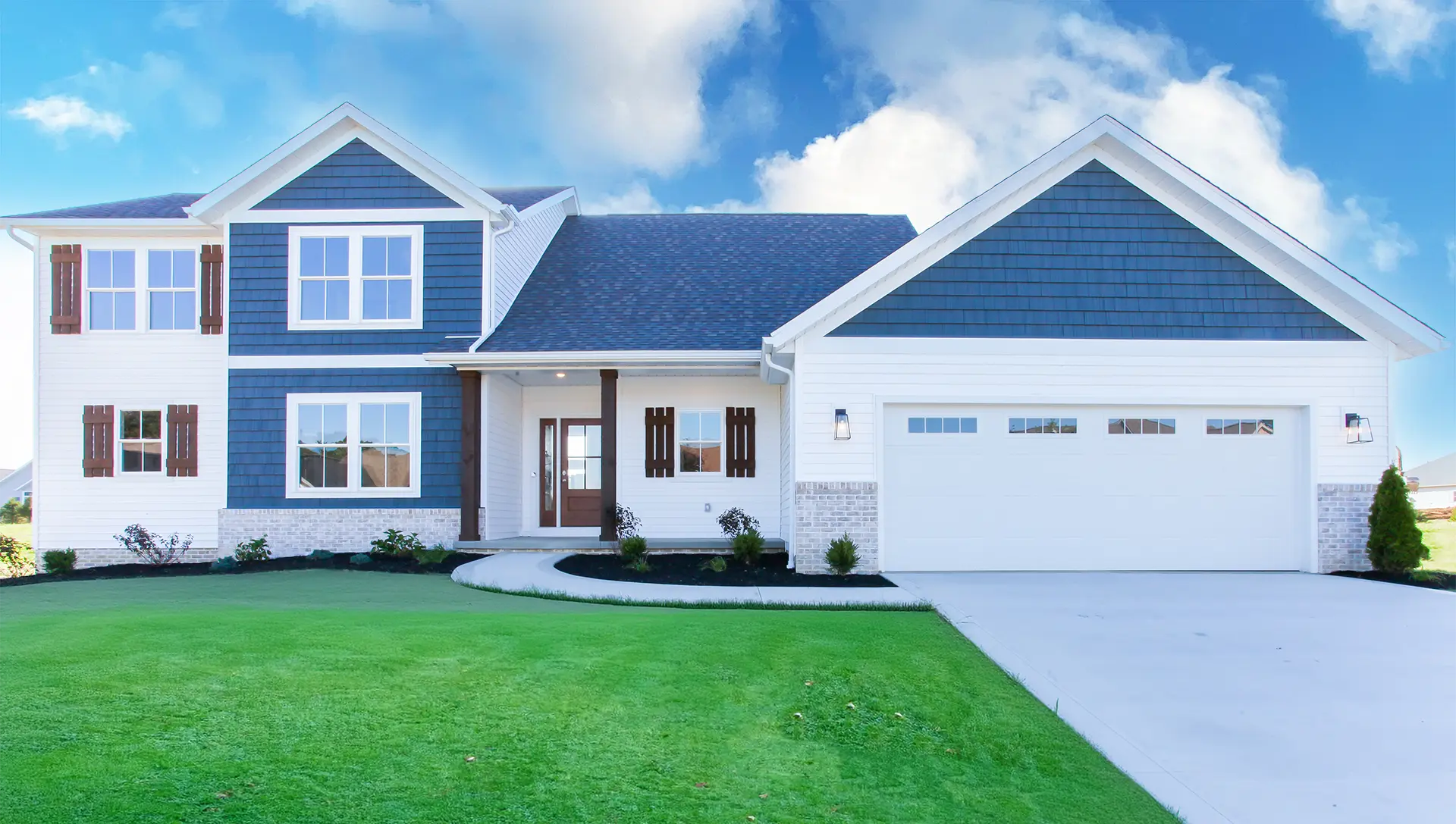 Finished home with blue and white siding whitewashed brick and a nice paved driveway and grass yard 