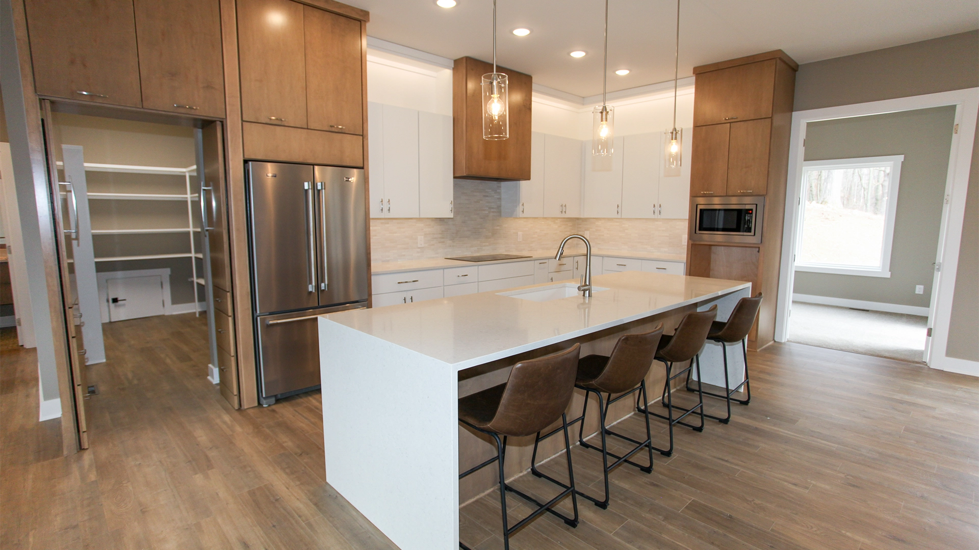 open kitchen concept with white island and bar countertop