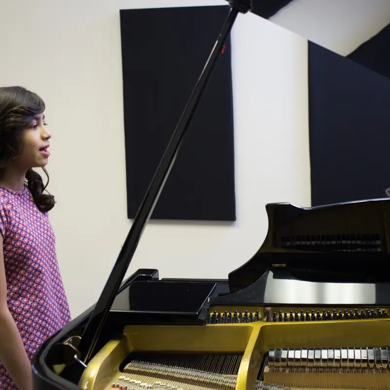 A student takes a music lesson with a teacher at Powell Academy of Music