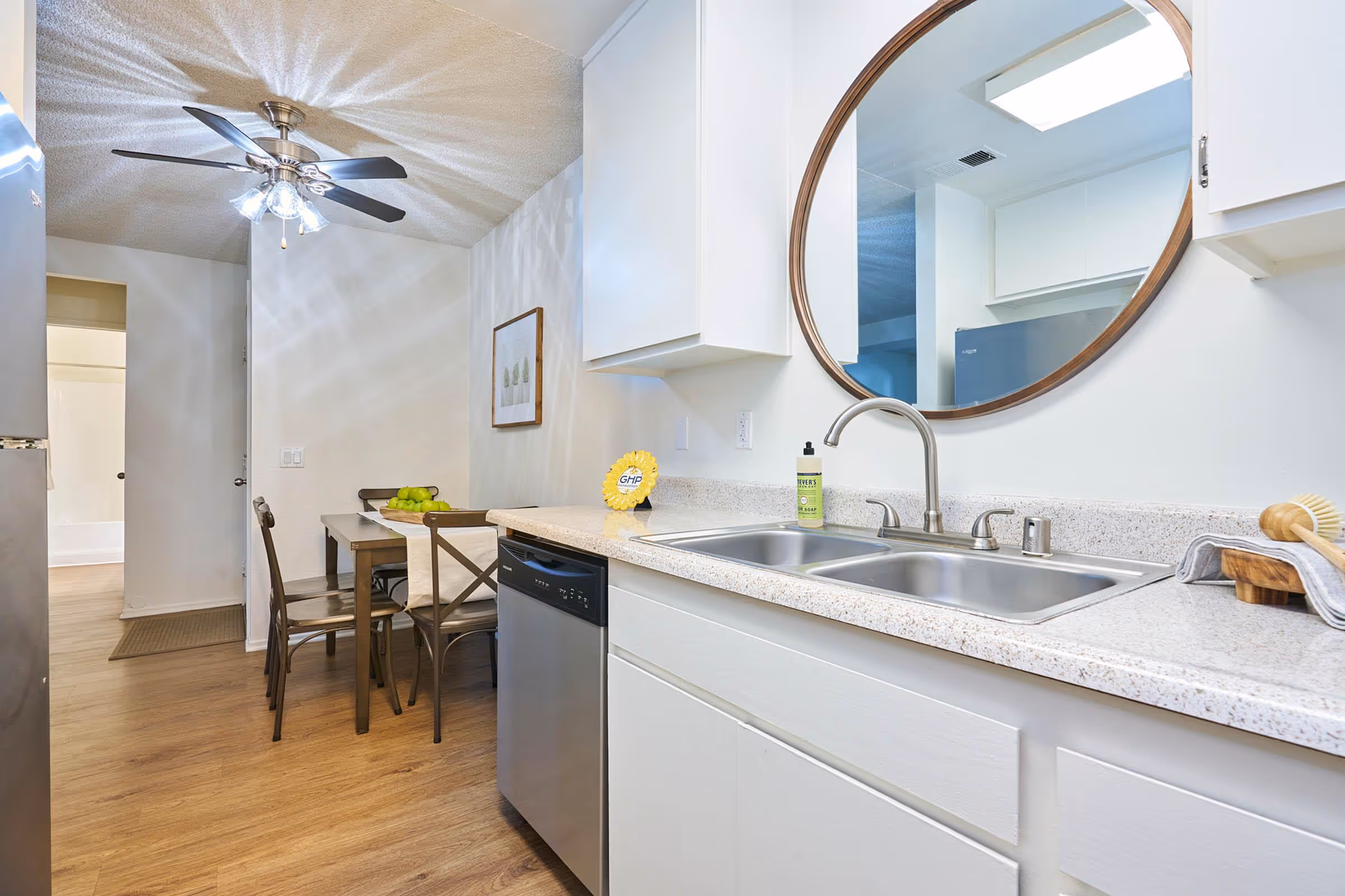Kitchen with white cabinets and stainless steel dishwasher