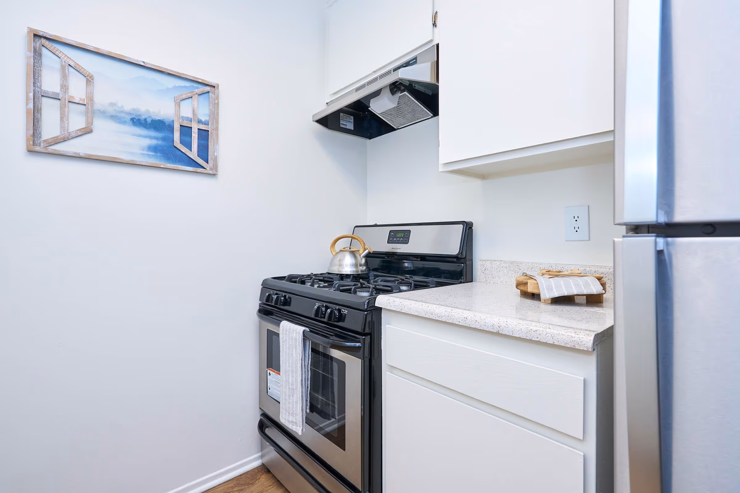 Kitchen with white cabinets and stainless steel stove