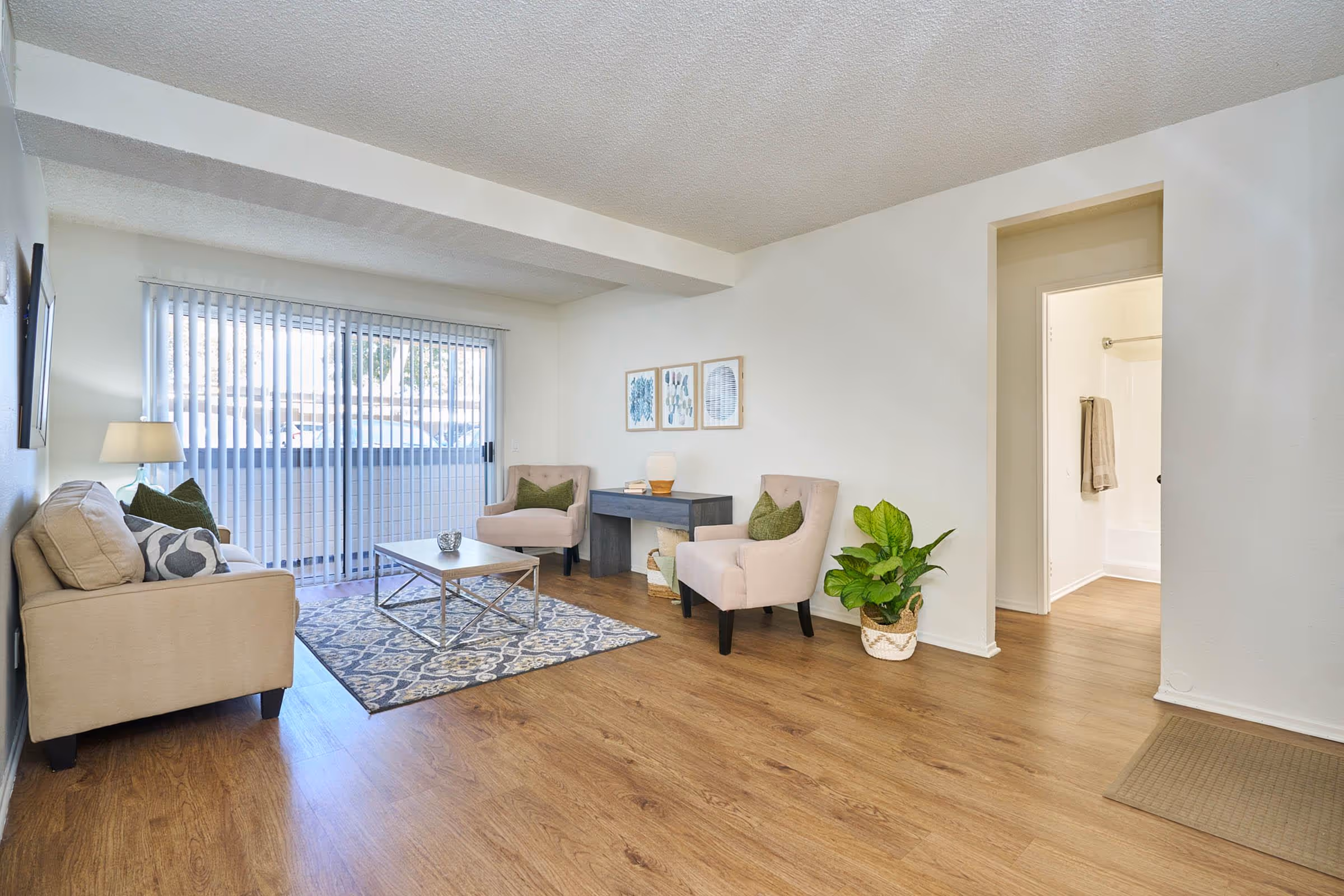 Living area with rug sofa, coffee table, and modern wall art