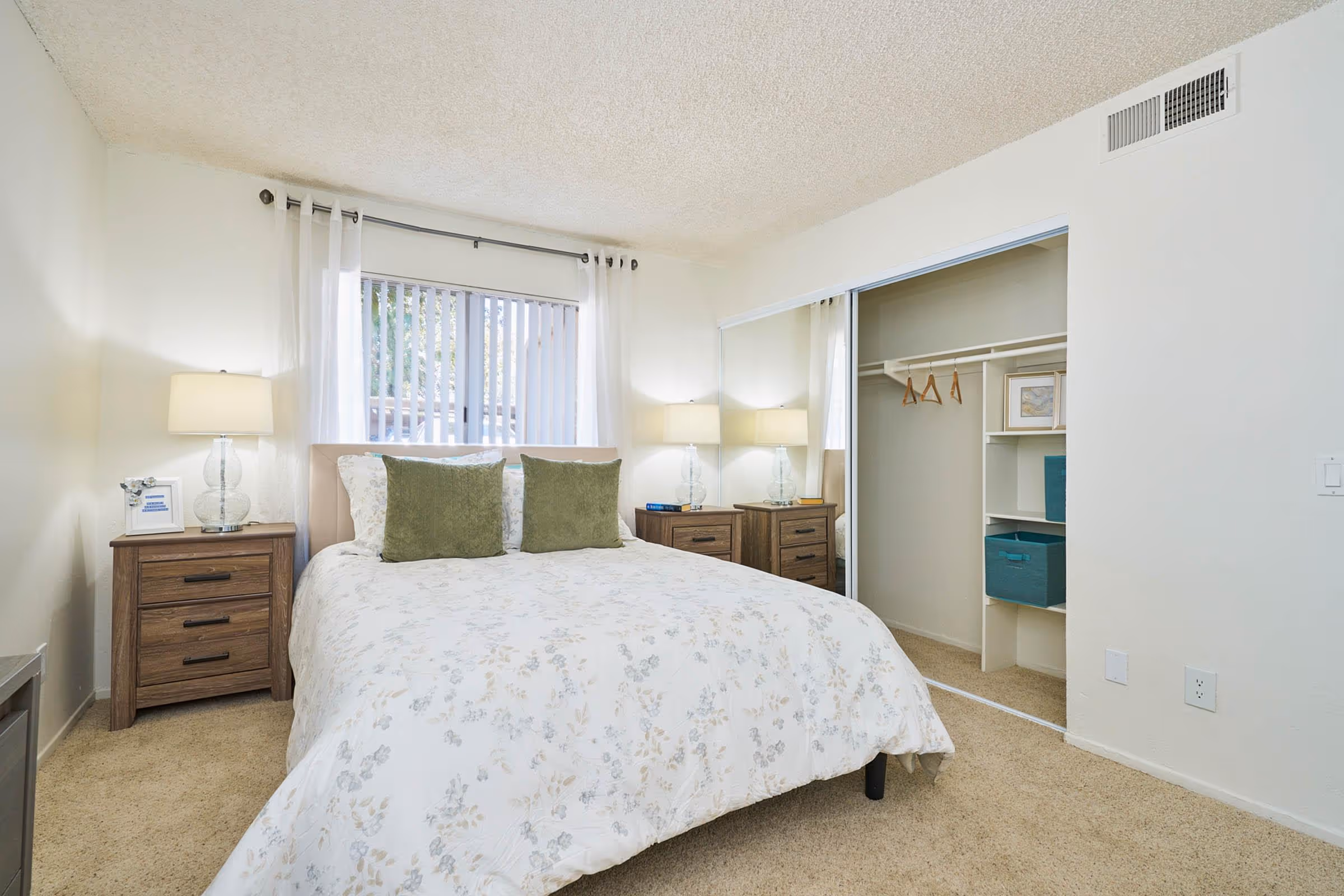 Bedroom with bed, dresser, and bedside tables featuring closet