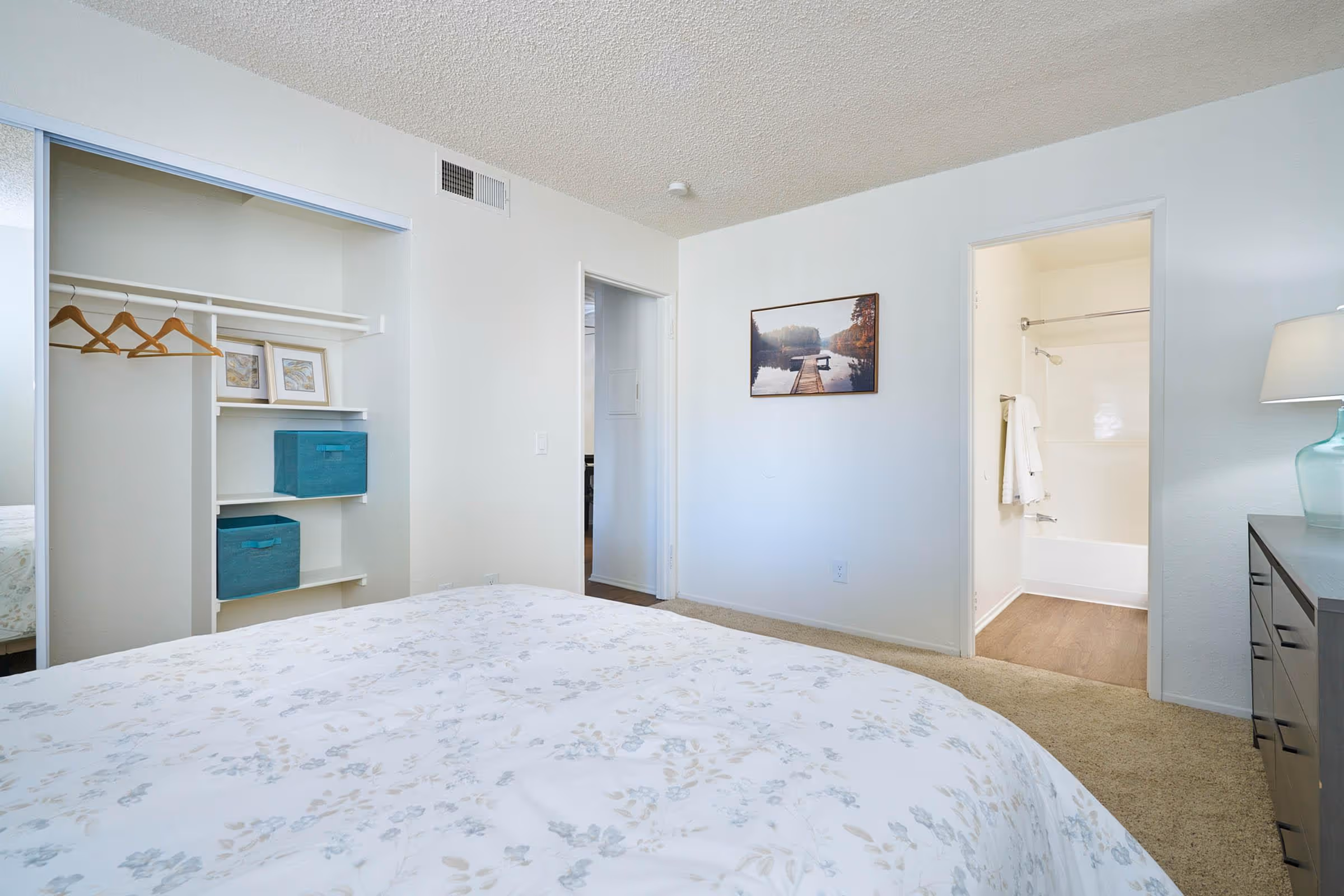 Bedroom with bed, dresser, and bedside tables featuring closet