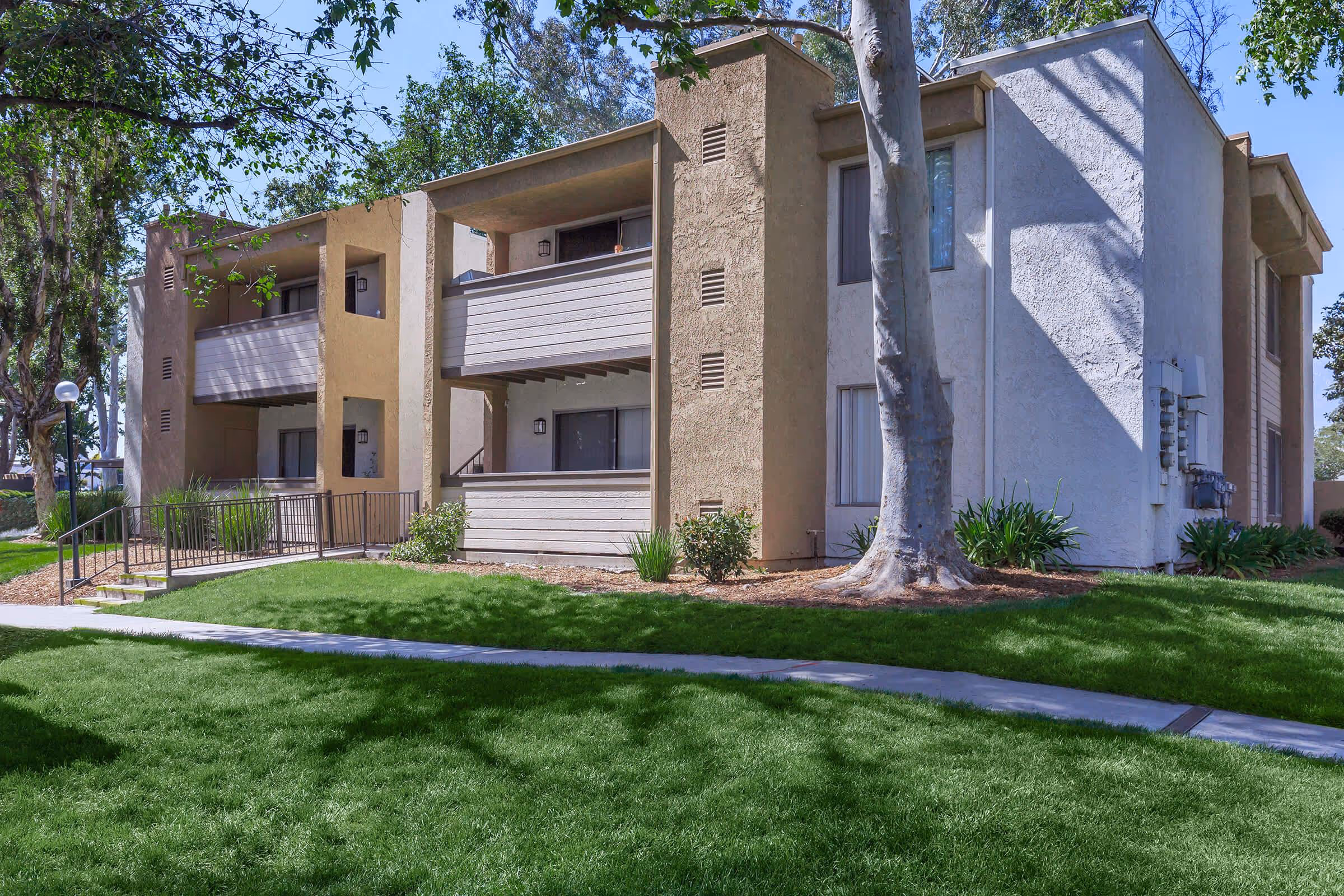 Exterior of apartment homes with walking paths and greenery