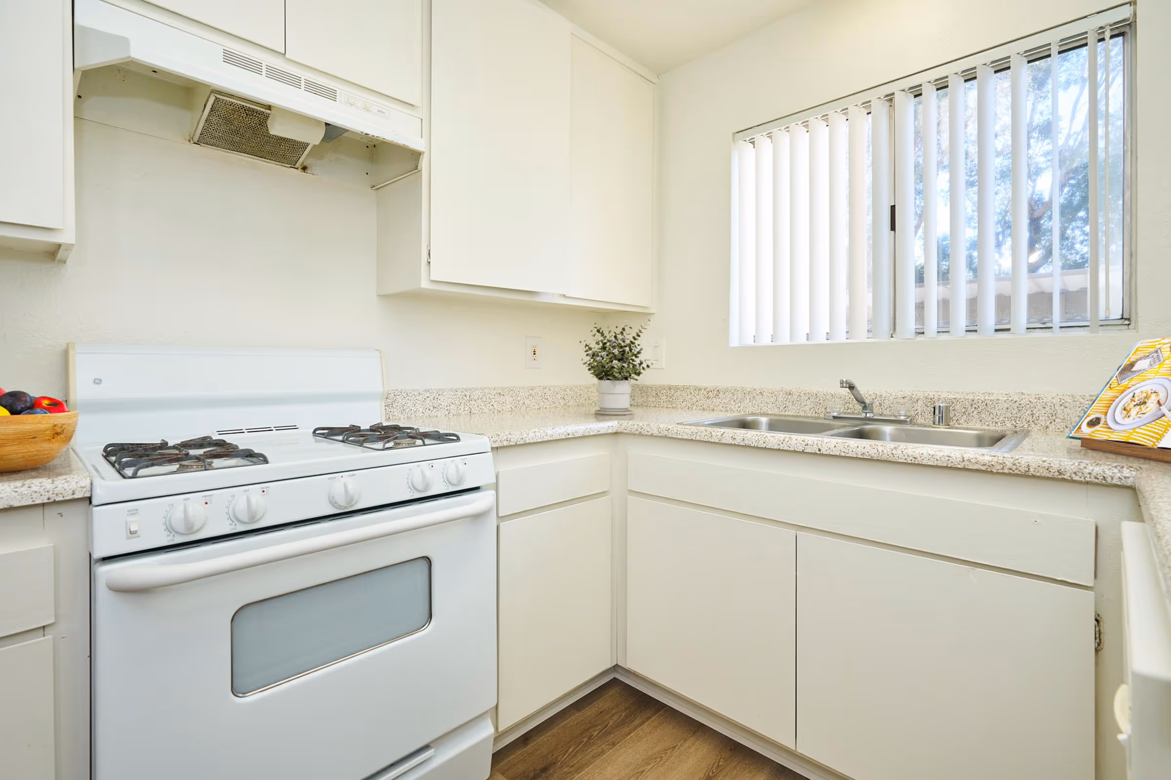 Kitchen with white cabinets and white appliances