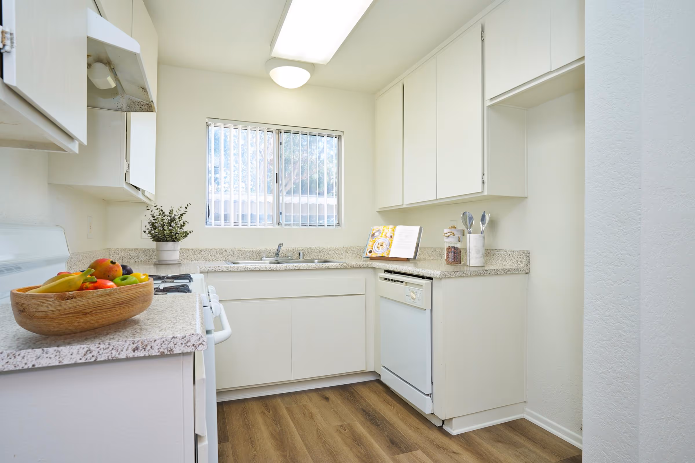 Kitchen with white cabinets and white appliances