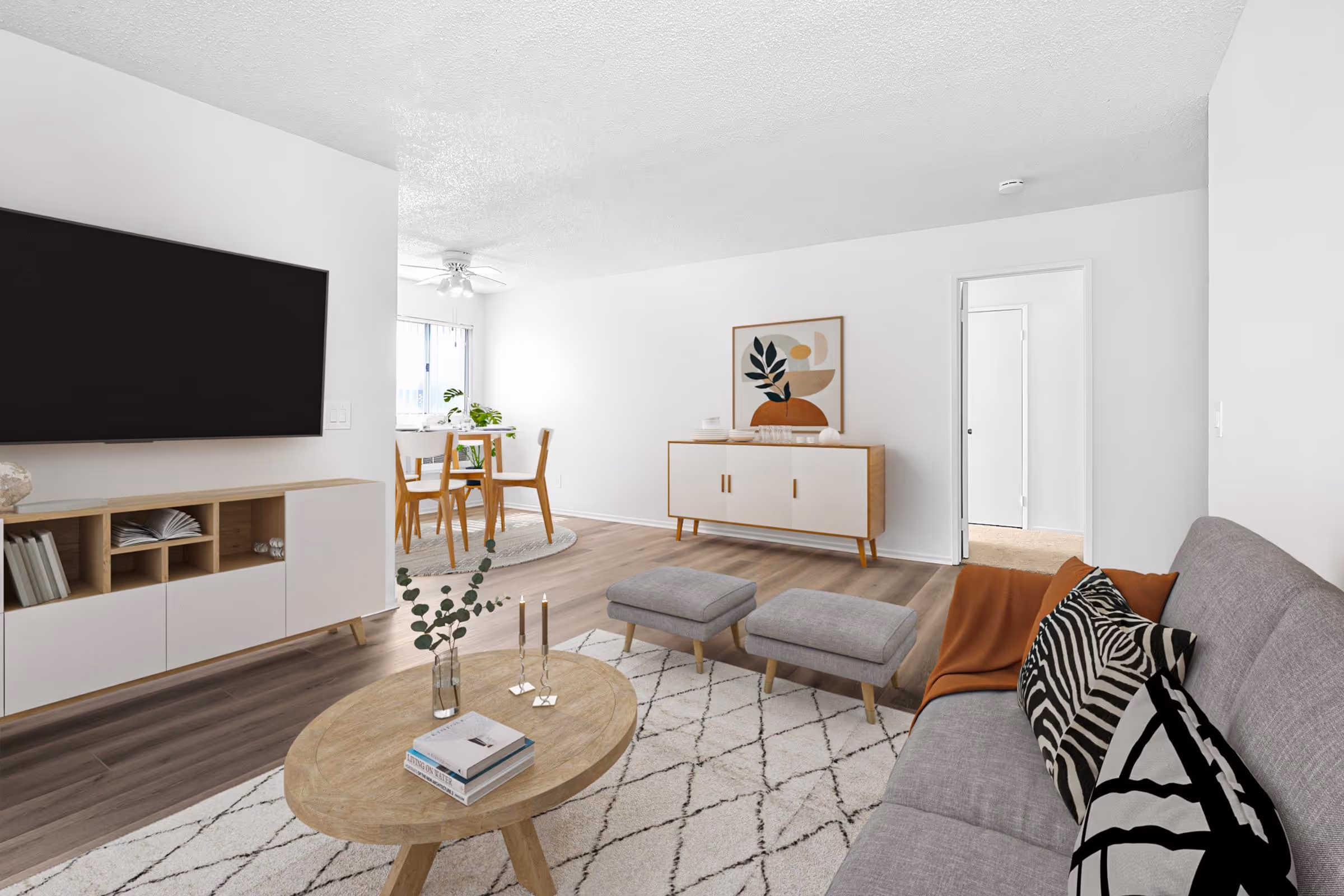 Virtually staged living area featuring sofa, coffee table, and tv