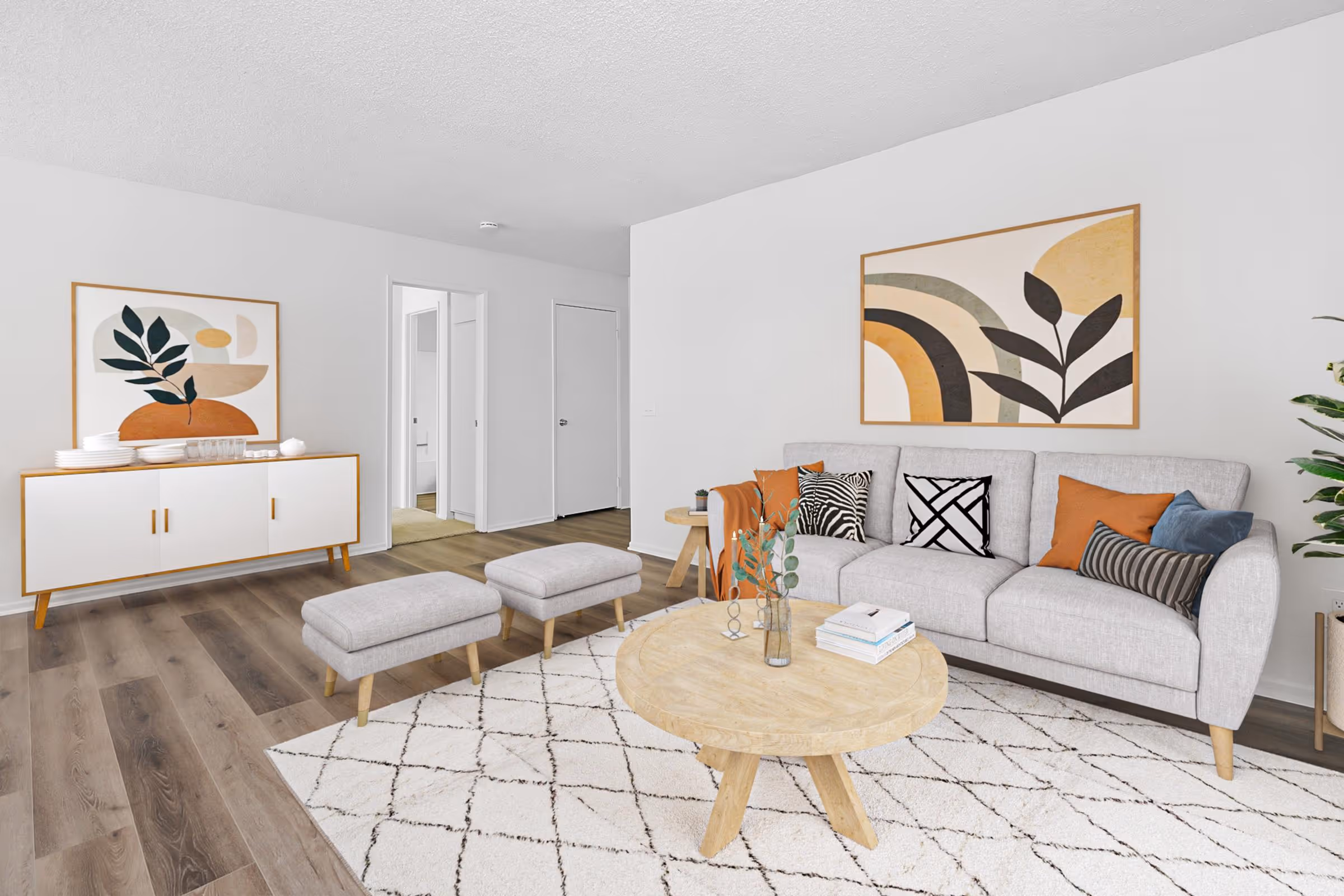 Virtually staged living area featuring sofa, coffee table, and wall art