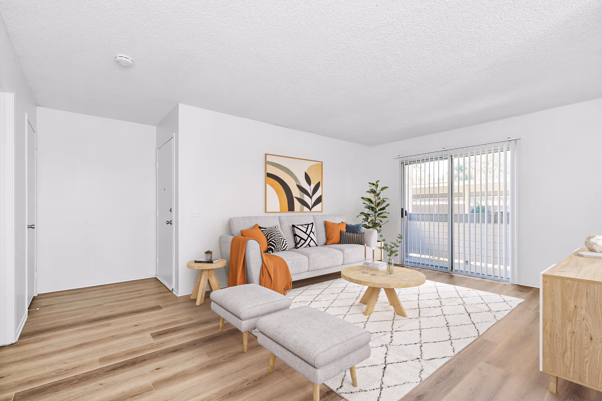 Virtually staged living area featuring sofa, coffee table, and large window