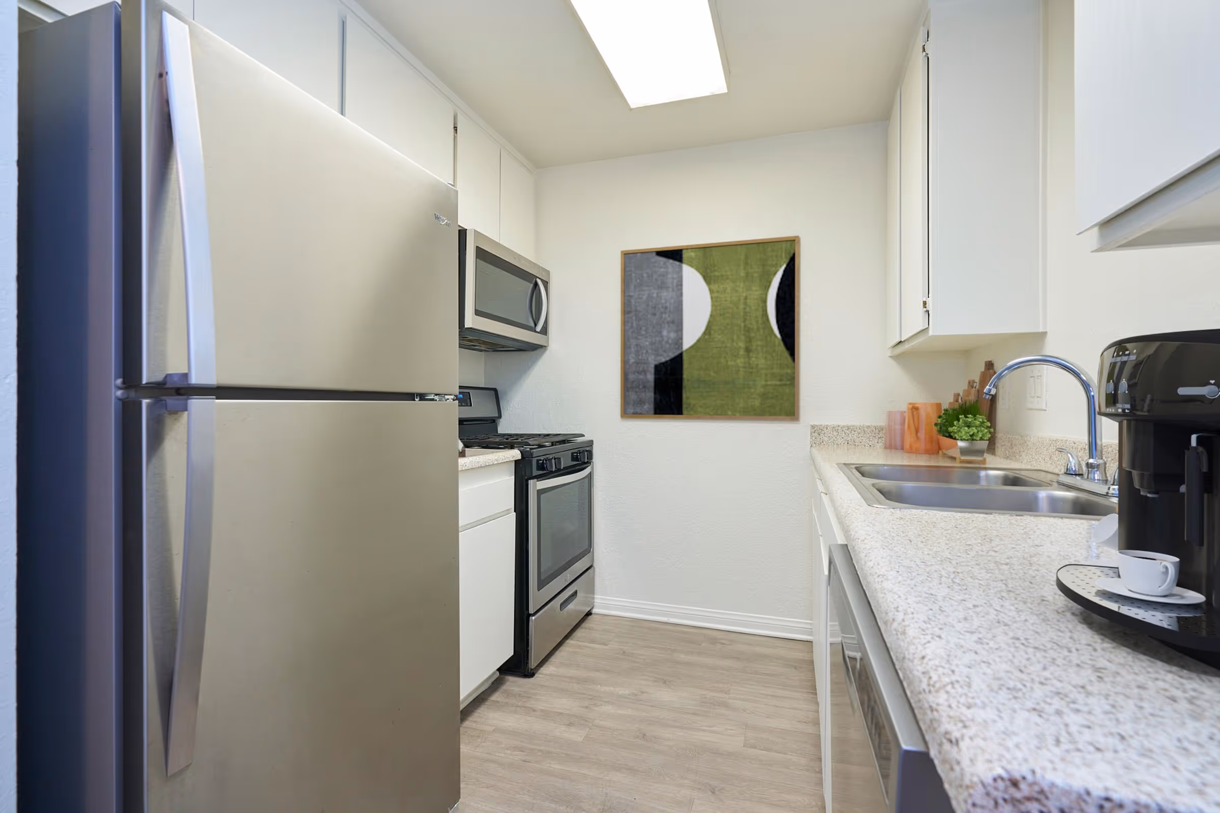 Kitchen with white cabinets and stainless steel appliances
