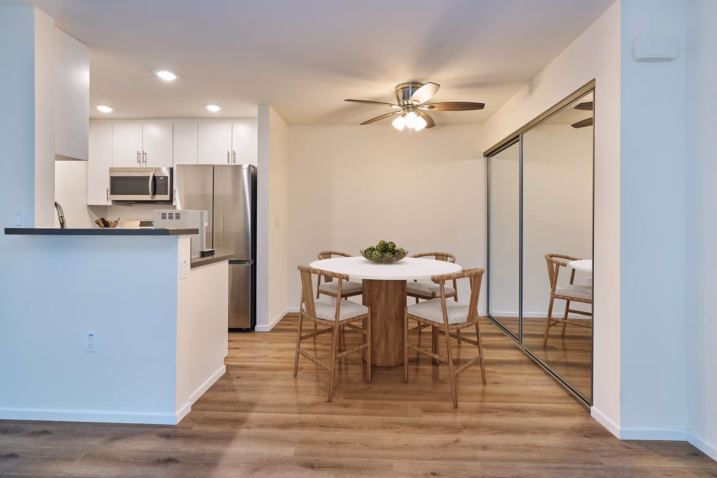 Wide view of Virtually staged dining area with table and chairs