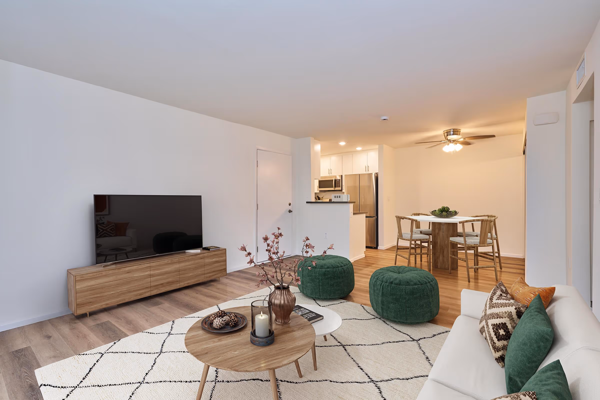 Wide view of Virtually staged living area with sofa, coffee table, and tv