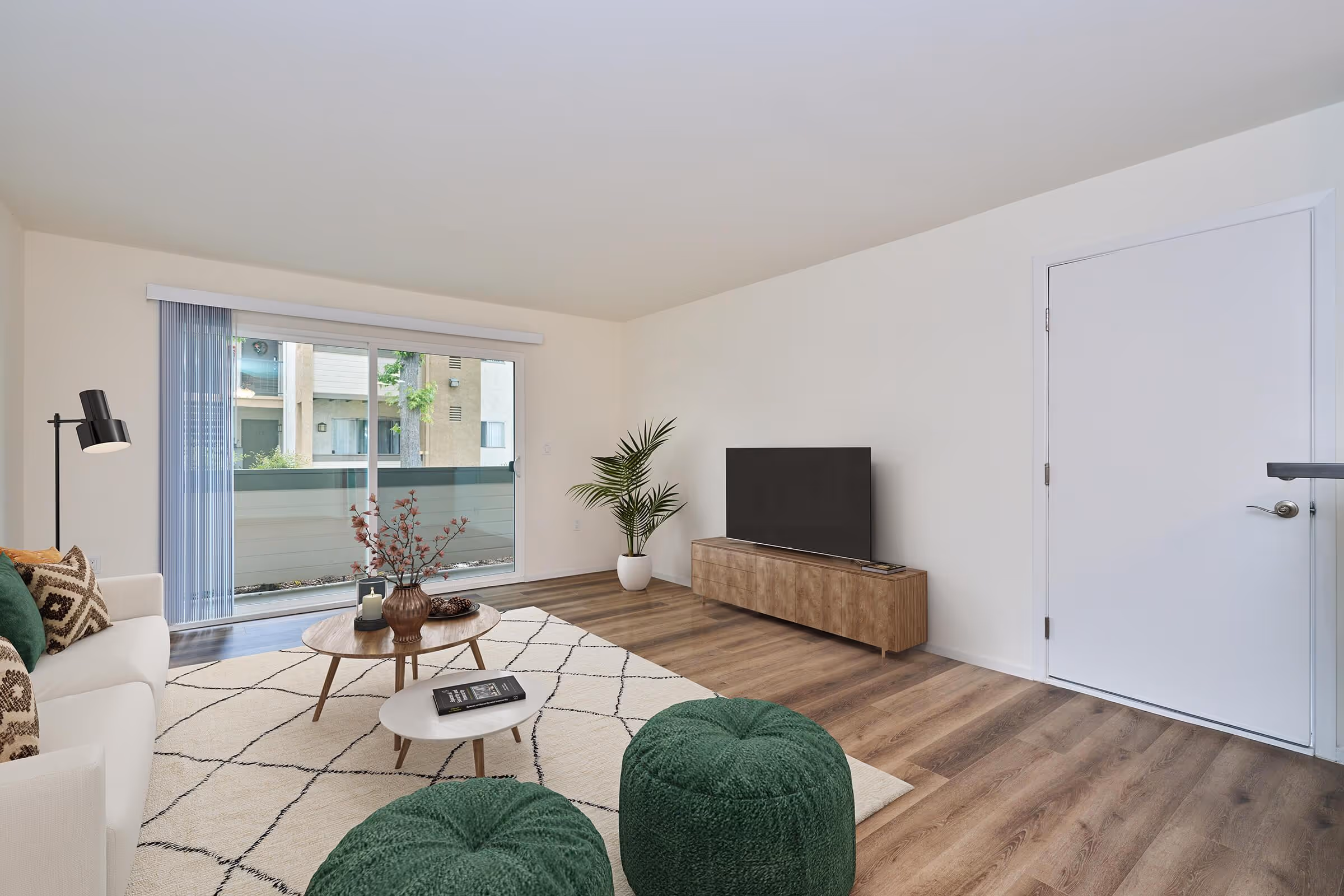 Wide view of Virtually staged living area with sofa, coffee table, and tv