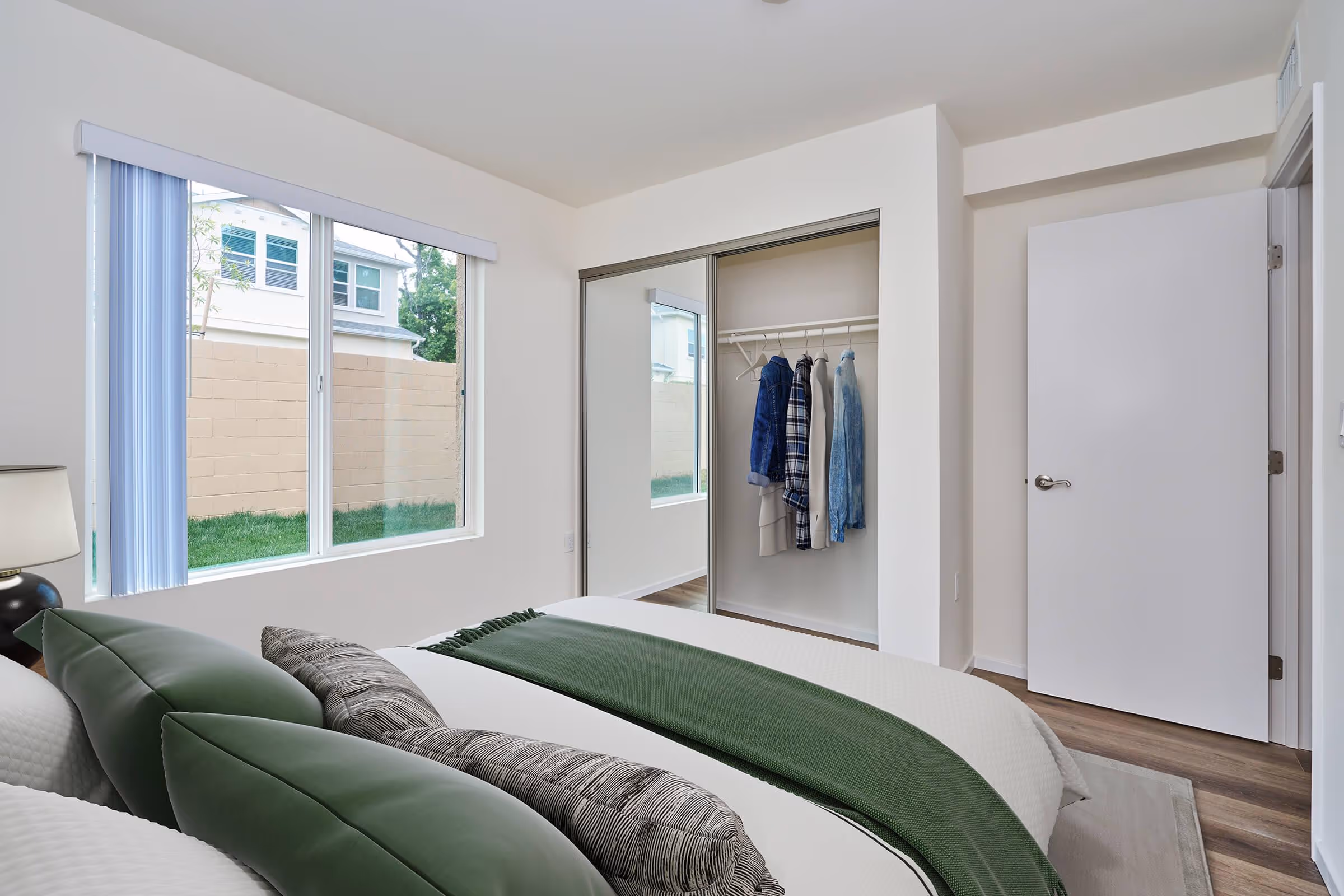 Virtually staged bedroom featuring bed, closet and large window