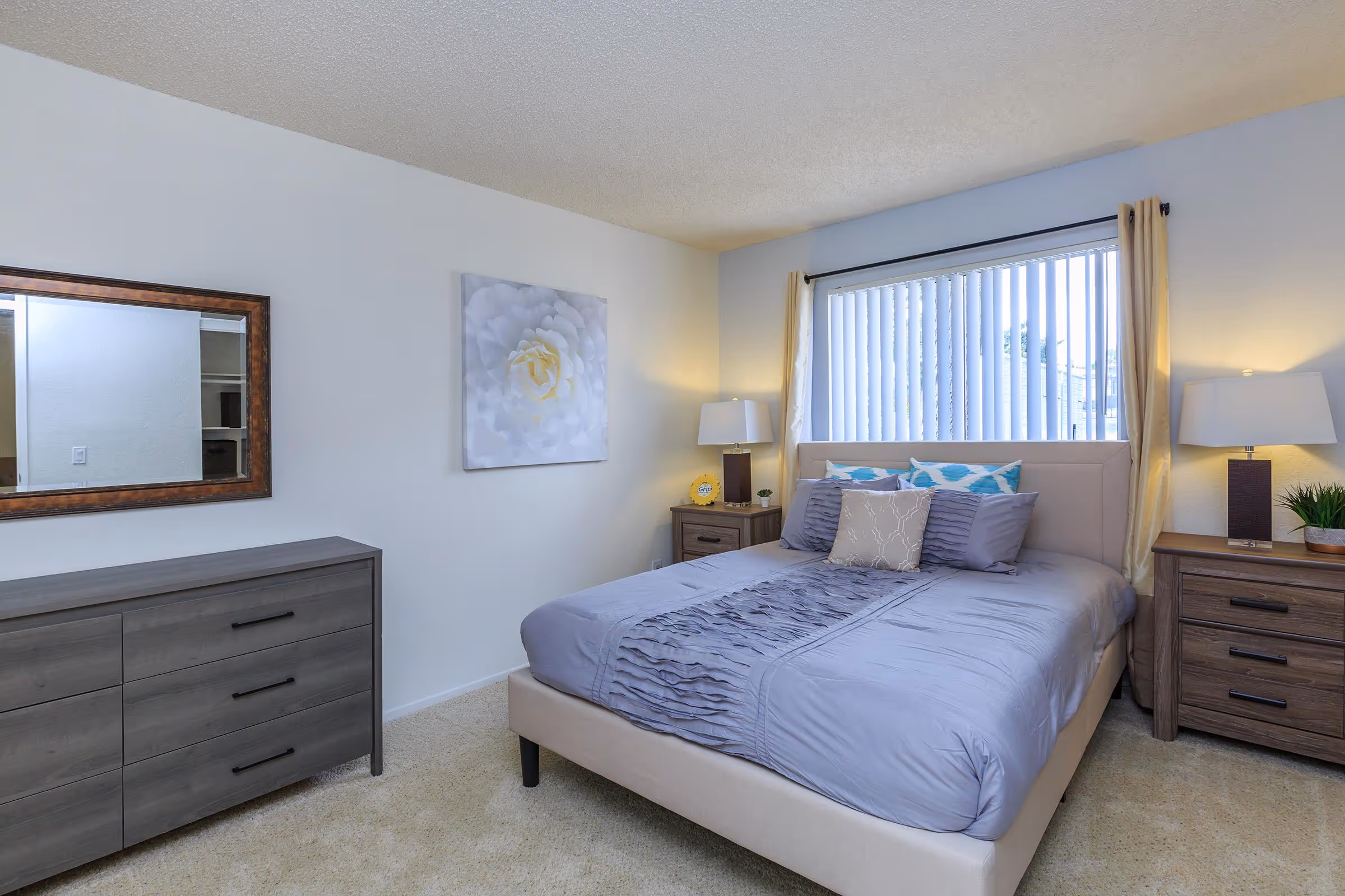 Bedroom featuring bed, bedside tables with lamps, and dresser